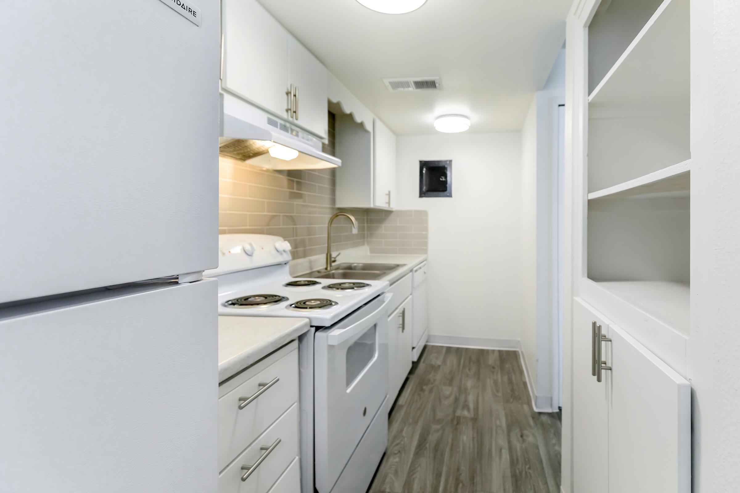 a kitchen with a sink and a refrigerator