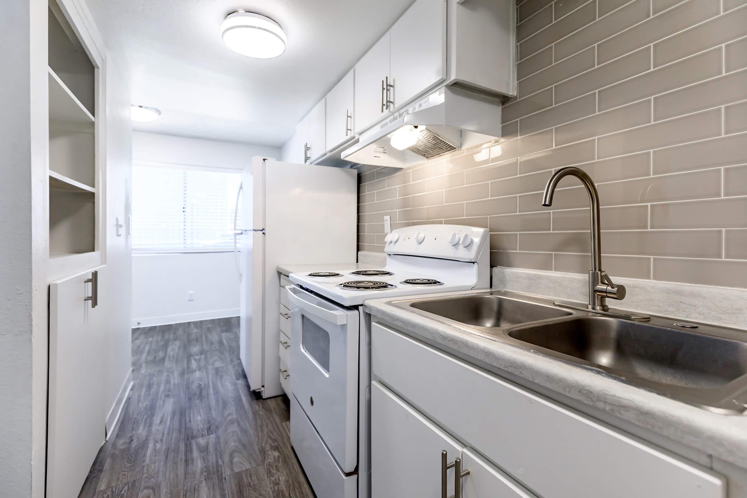 a kitchen with a stove and a sink