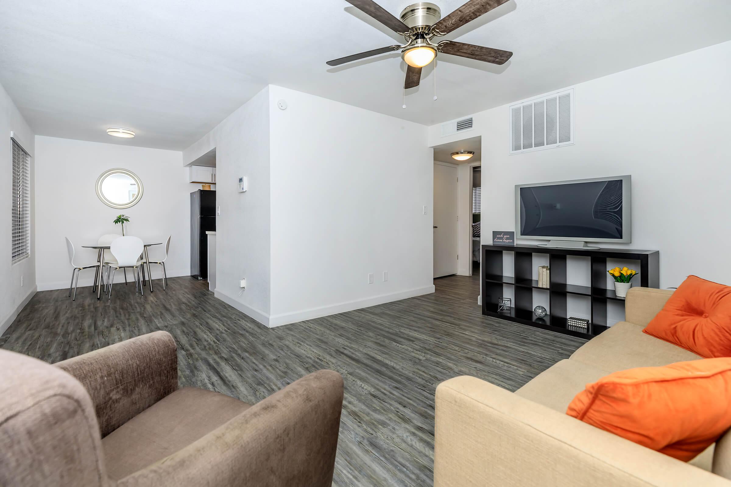 a living room filled with furniture and a flat screen tv