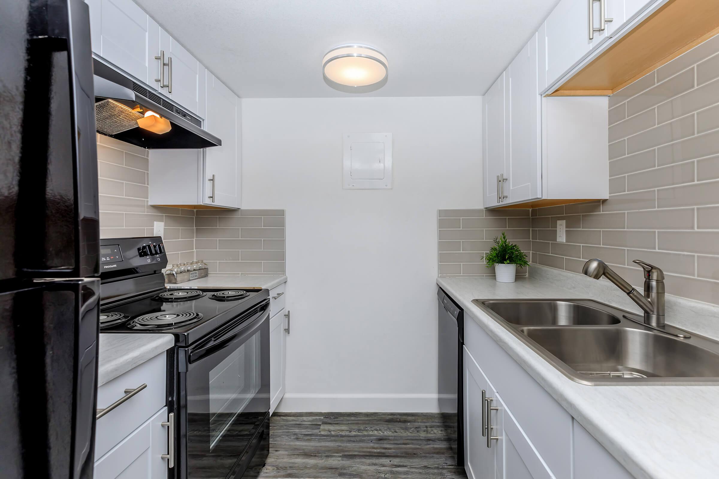 a kitchen with a stove and a sink