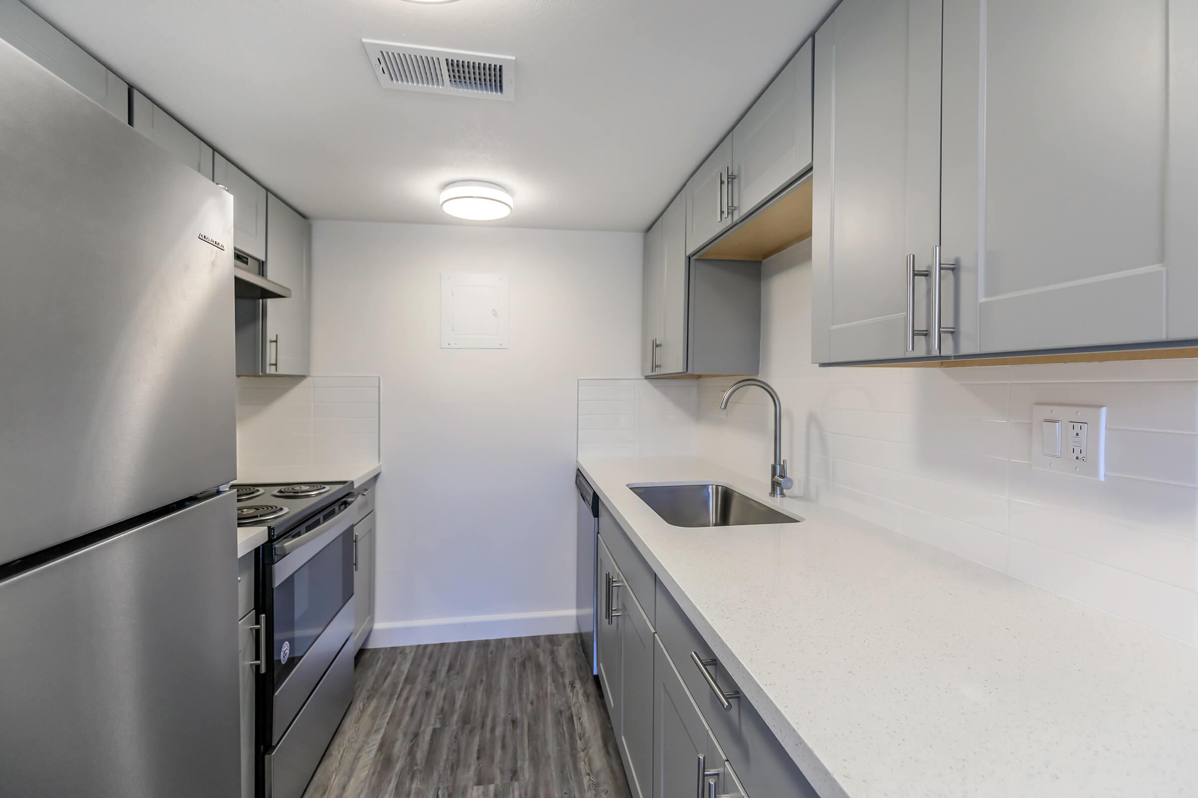 a kitchen with a sink and a refrigerator