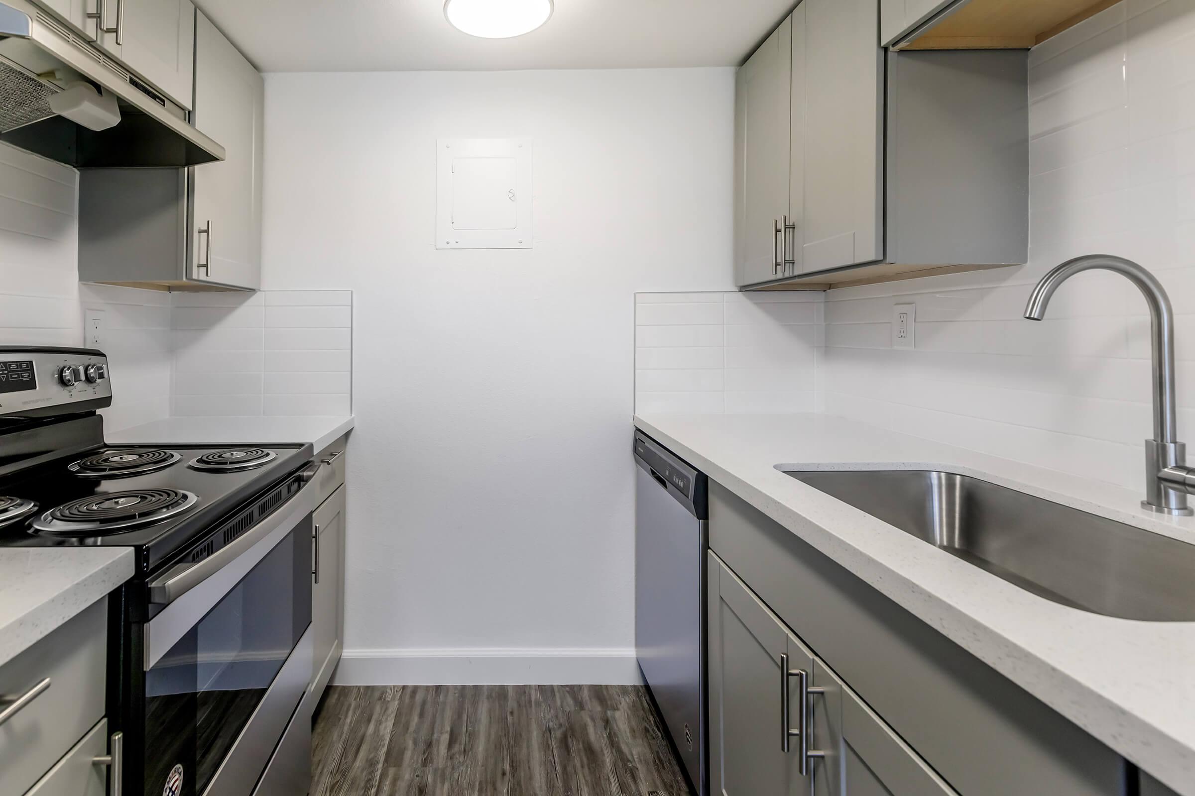 a kitchen with a stove and a sink