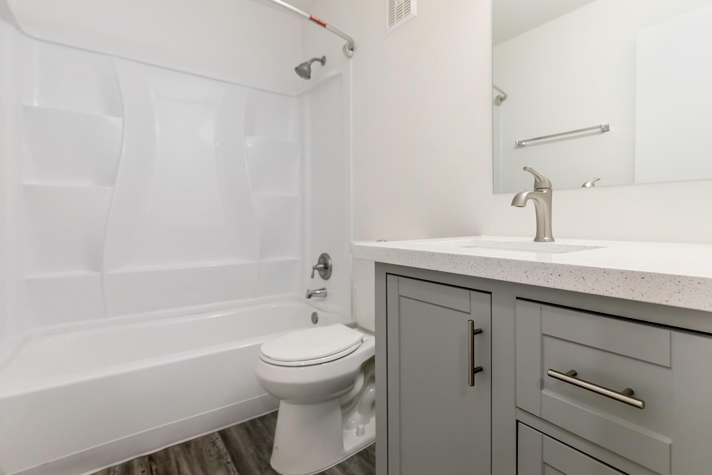 a sink sitting under a mirror