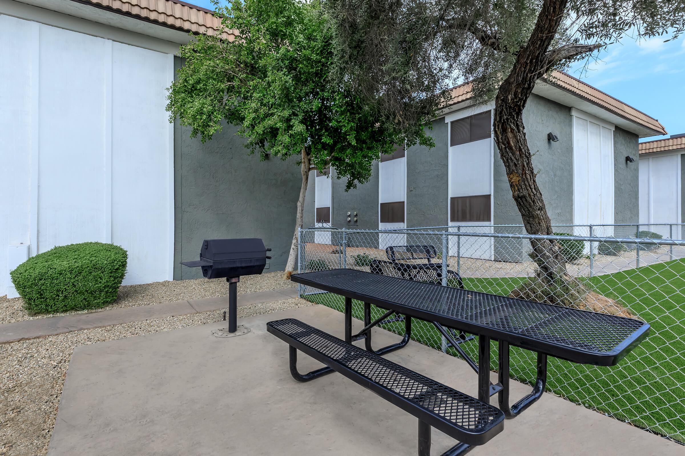 a couple of lawn chairs sitting on a bench in front of a building