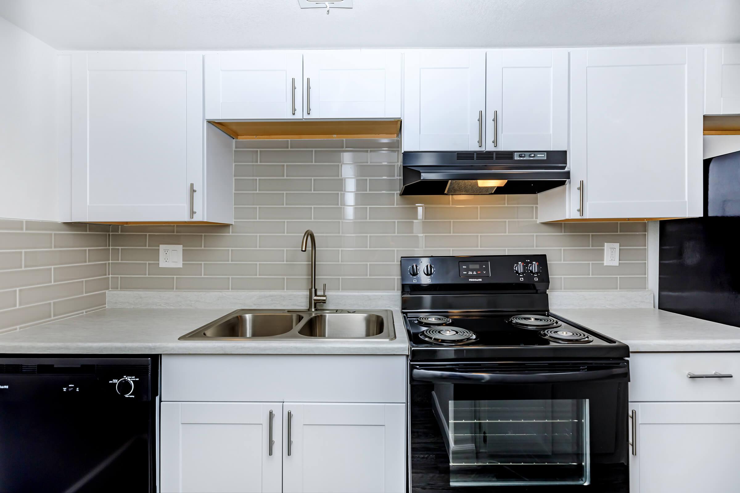 a stove top oven sitting inside of a kitchen