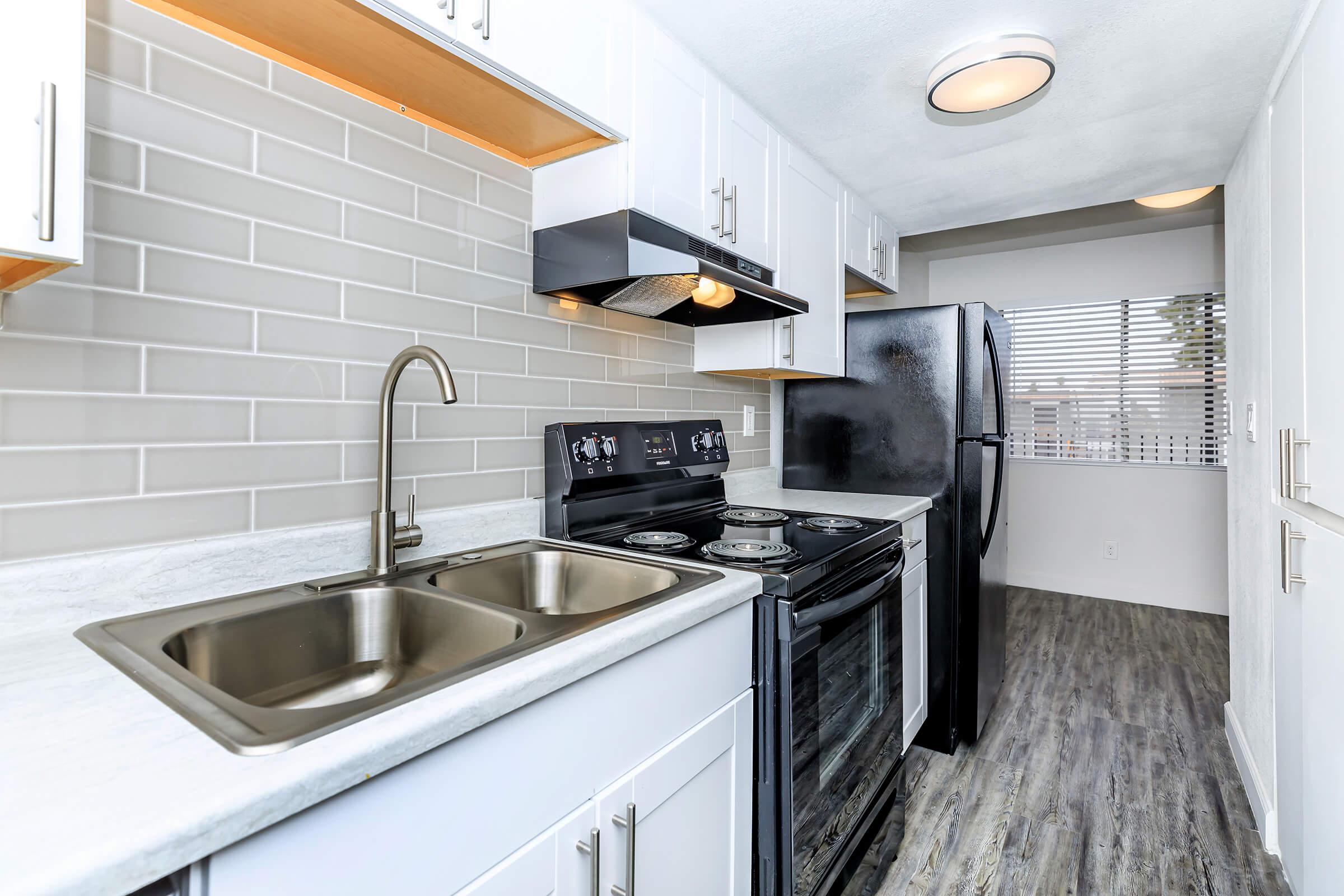 a kitchen with a stove and a sink