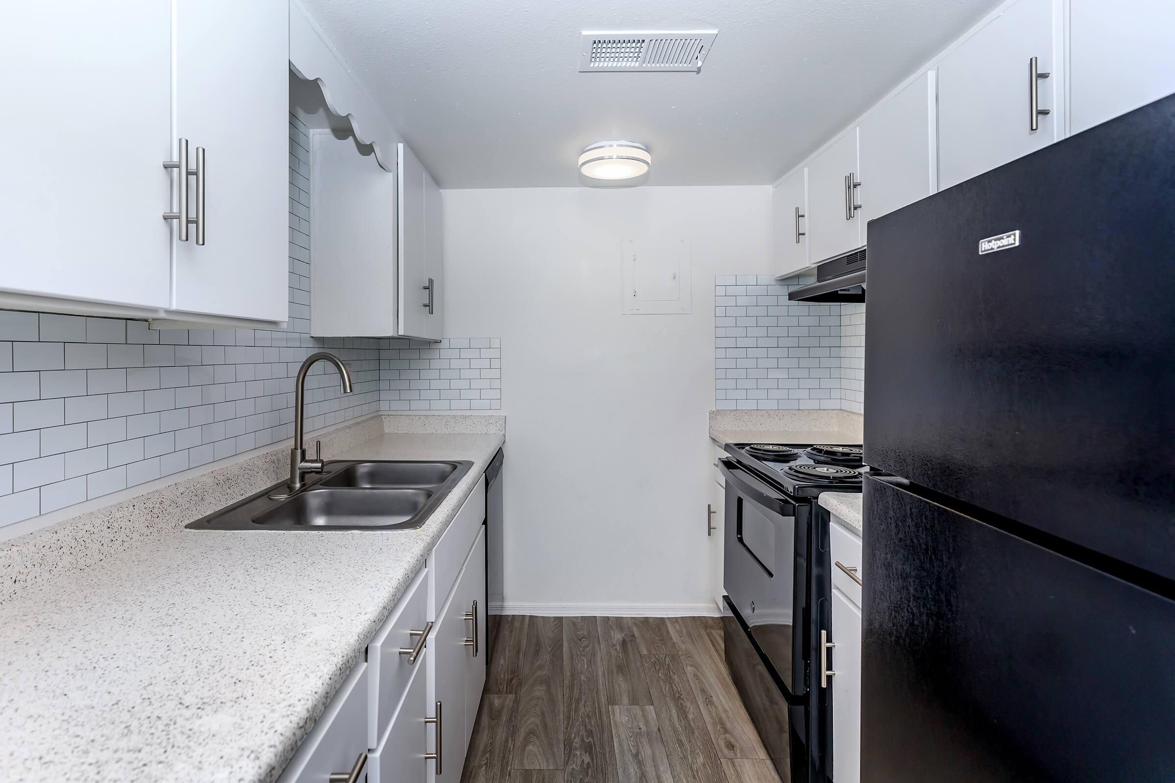 a large kitchen with stainless steel appliances