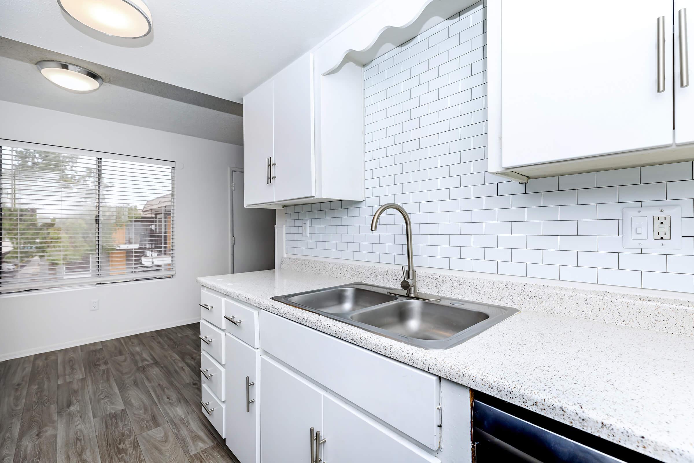 a kitchen with a sink and a window