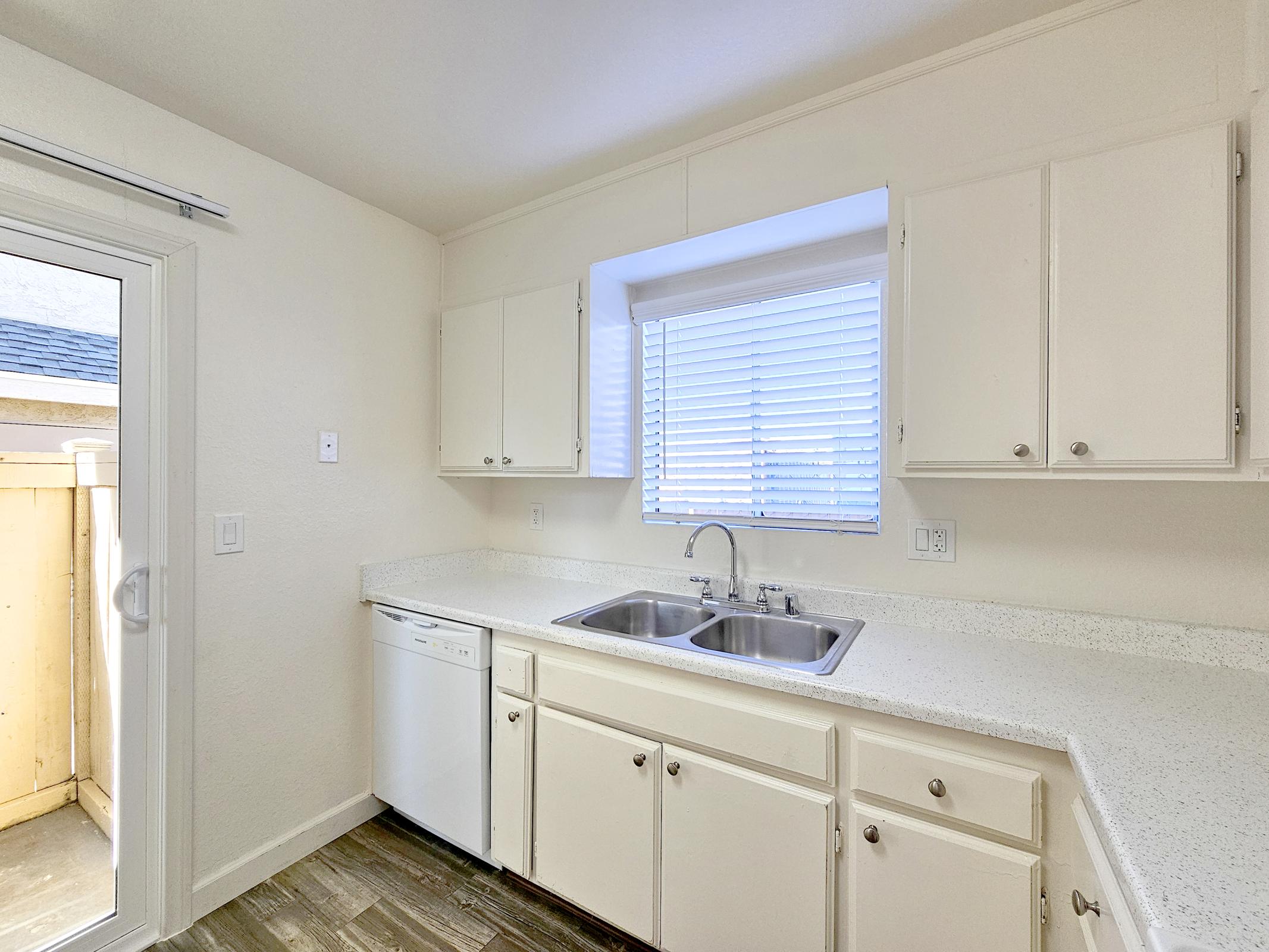 a kitchen with a sink and a window