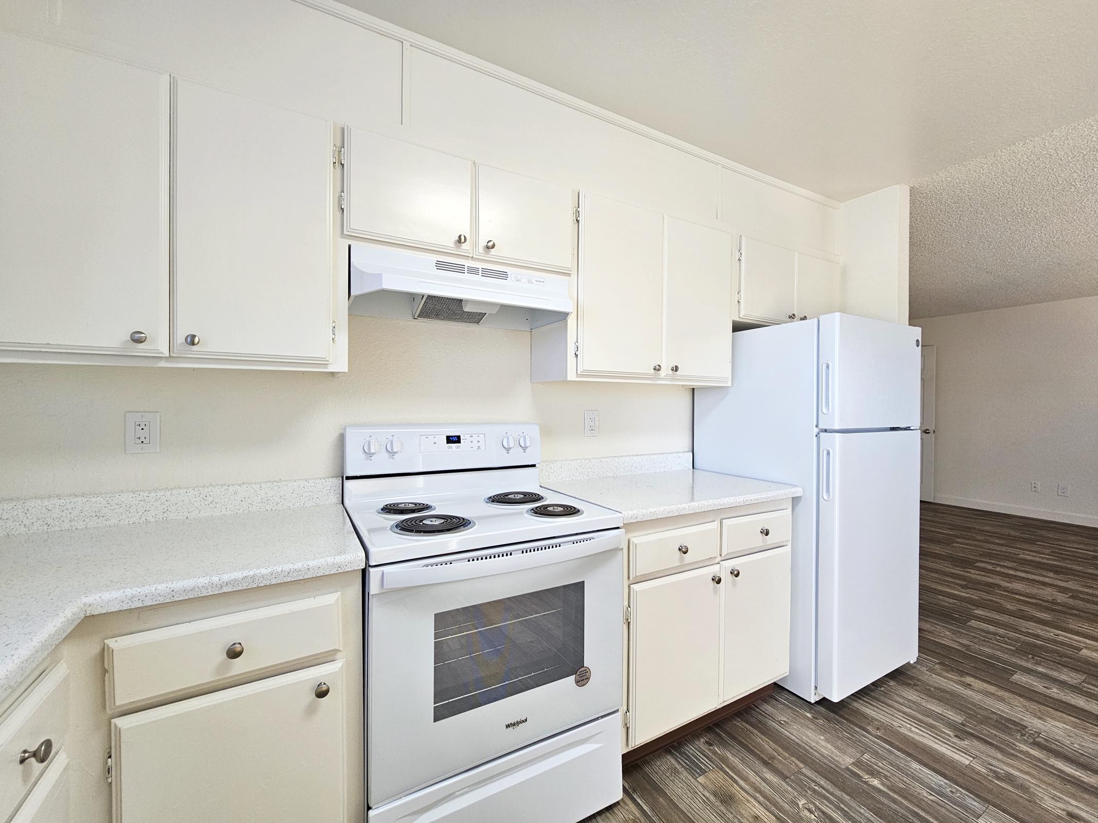 a stove top oven sitting inside of a kitchen