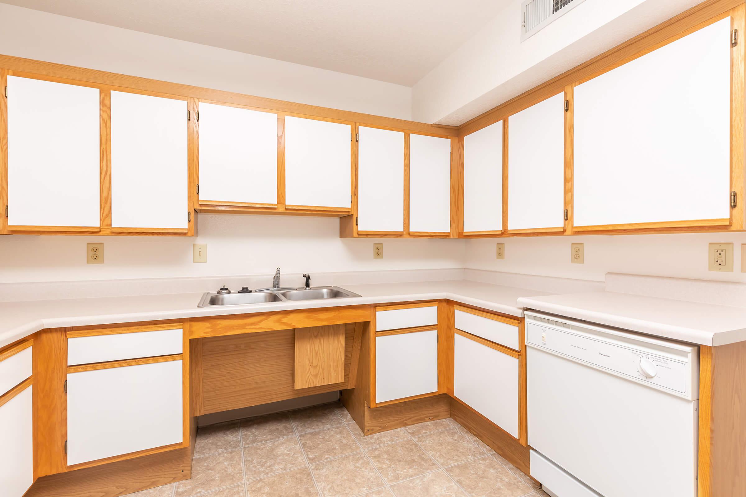 a kitchen with wooden cabinets and a window