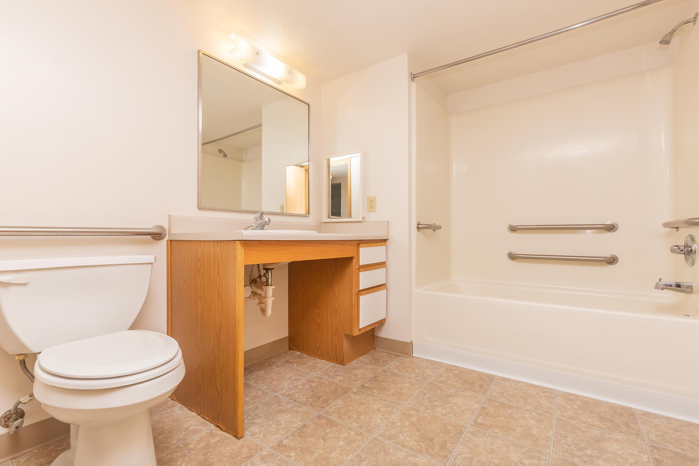 a large white tub sitting next to a sink