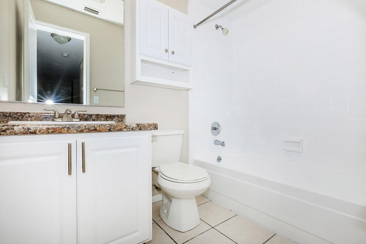 a large white tub next to a sink