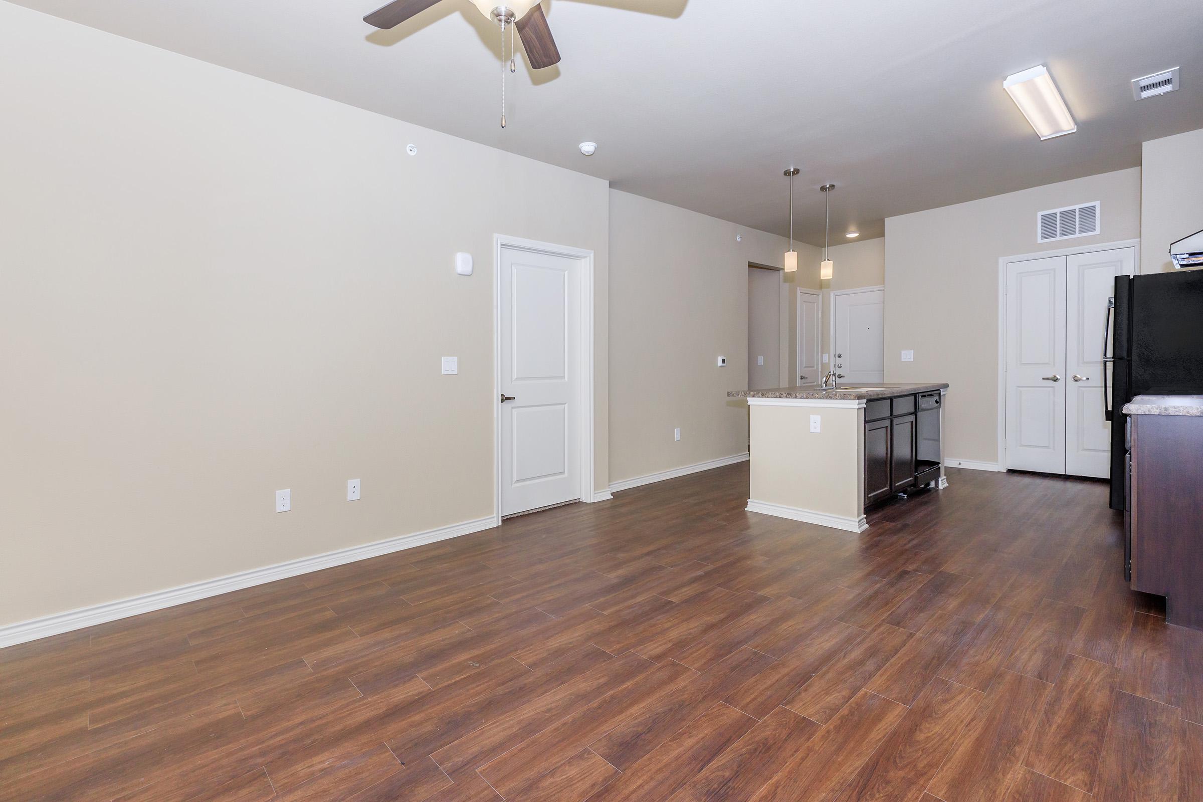 a large empty room with a wood floor