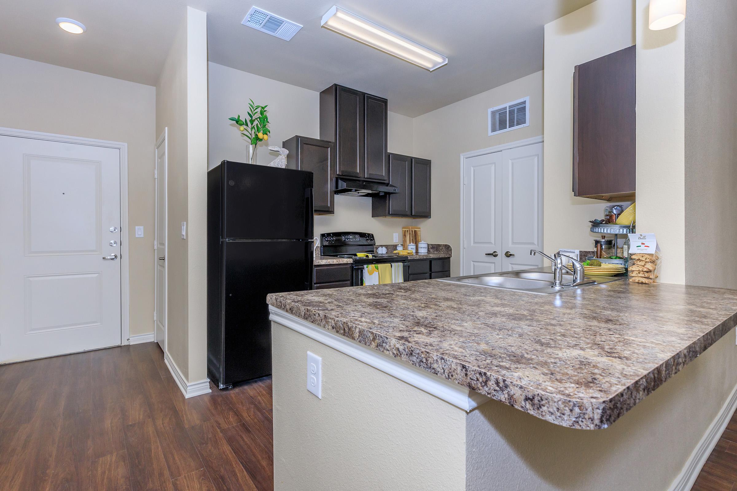 a kitchen with a sink and a mirror