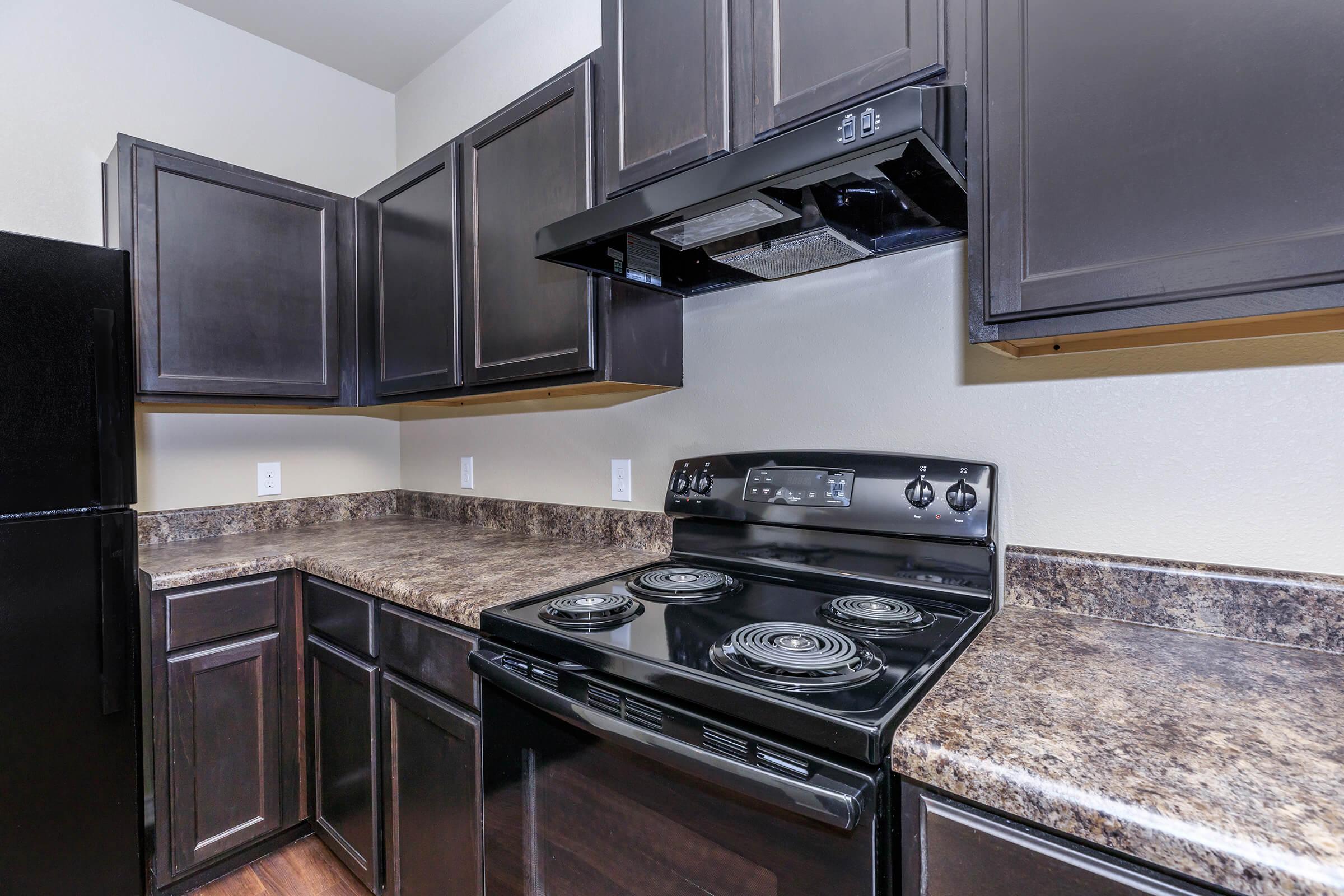 a modern kitchen with stainless steel appliances and wooden cabinets