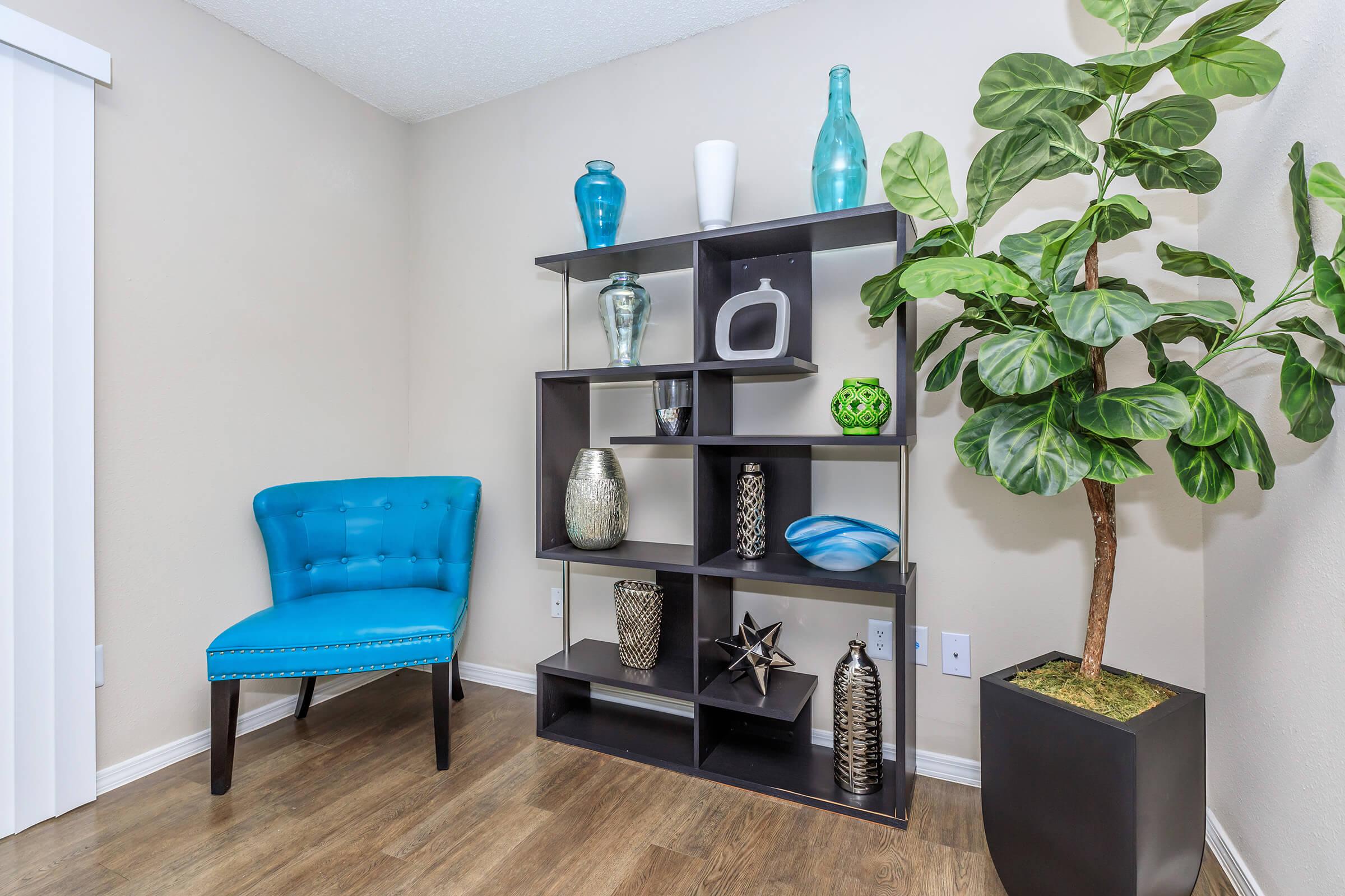 a living room with blue chairs and a table