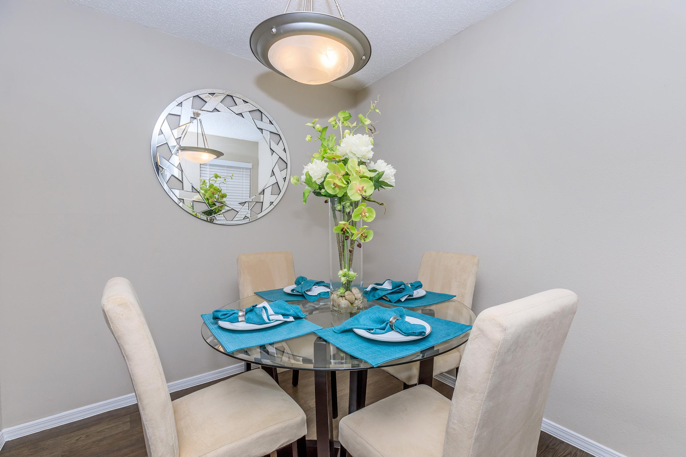 a room filled with furniture and vase of flowers on a table