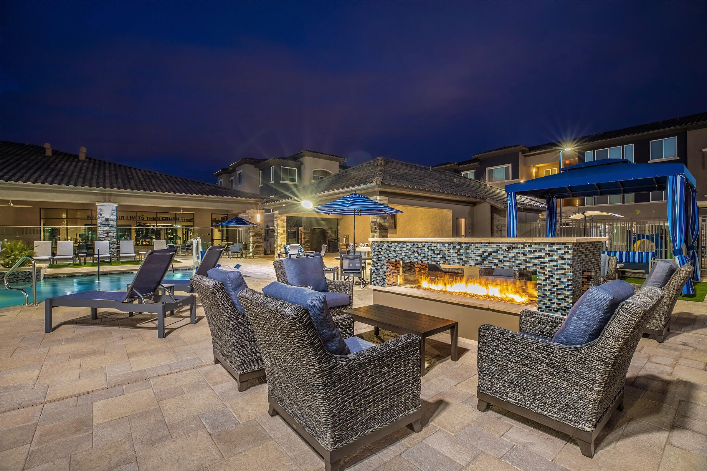 Blue wicker chairs in front of the outdoor fireplace
