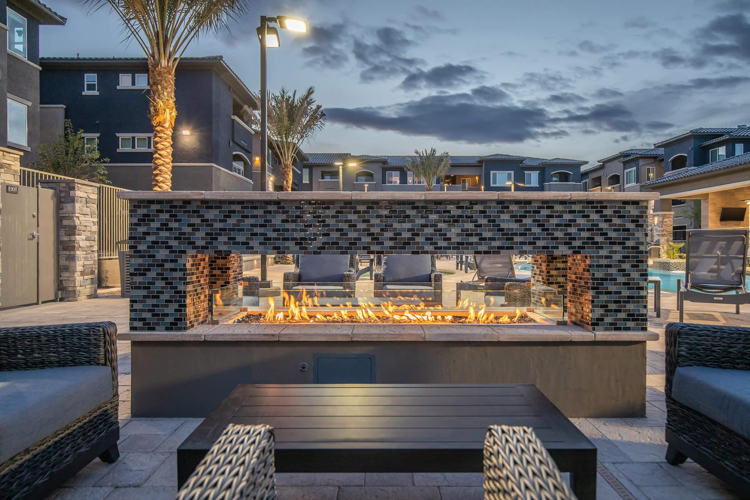 Lit outdoor fireplace with mosaic tiles