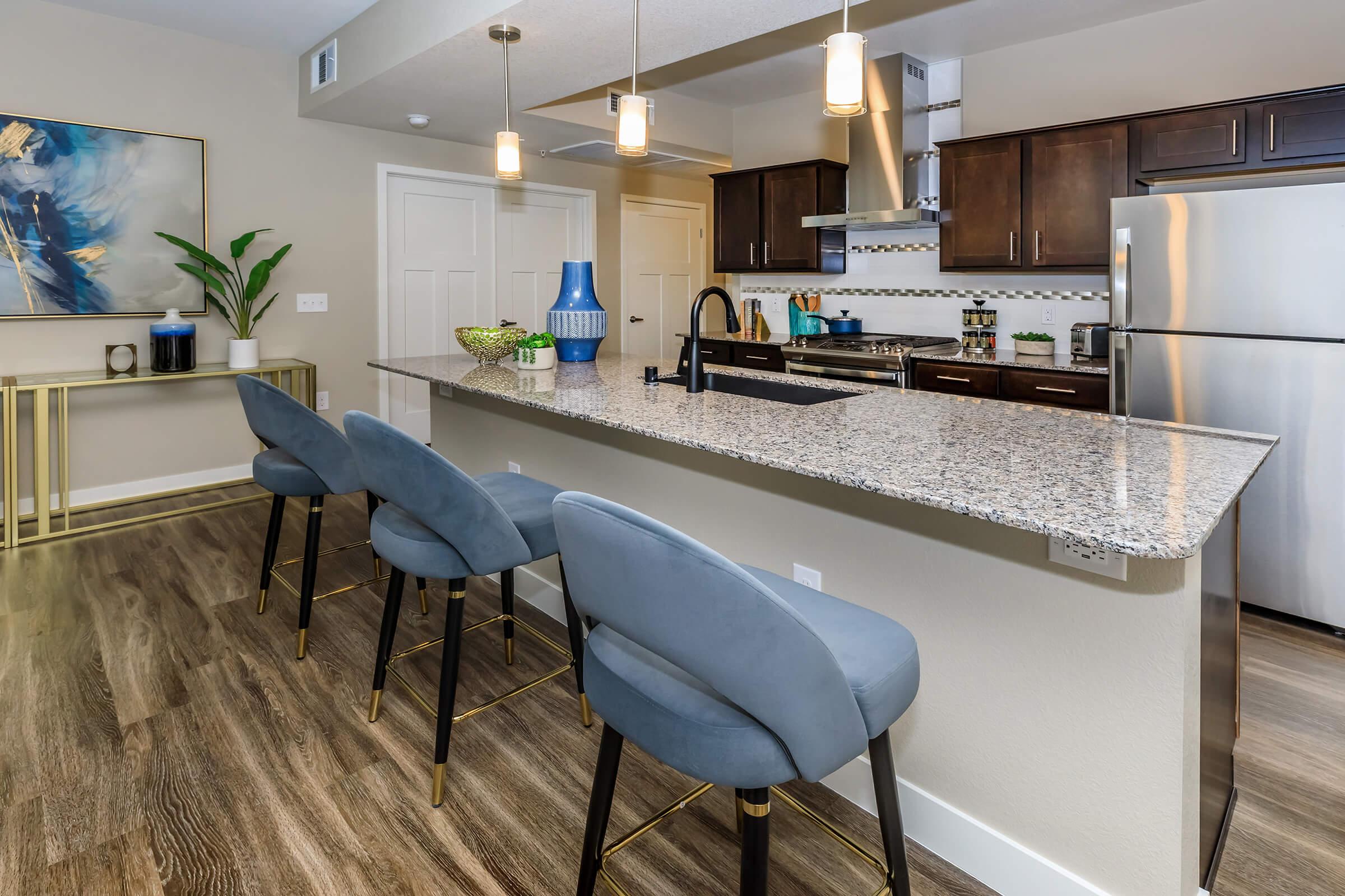 Kitchen counter with blue chairs