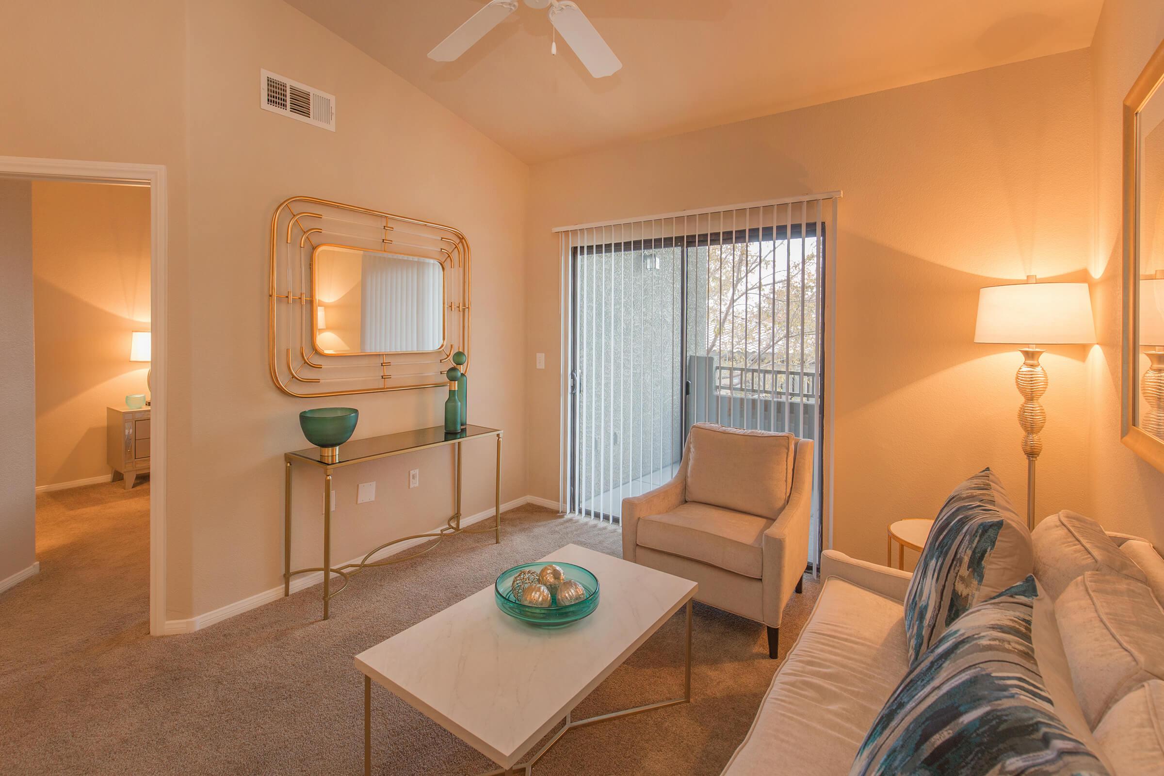 a living room with a bed and a mirror