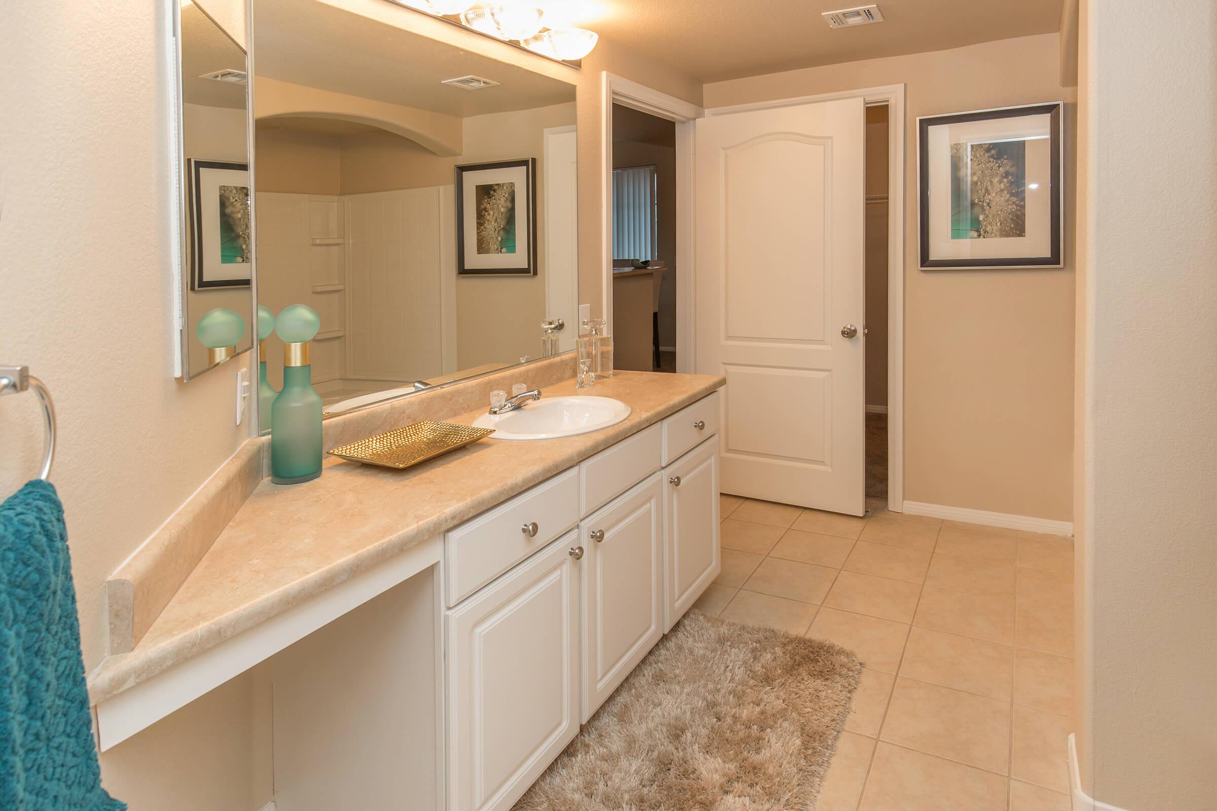 a kitchen with a sink and a mirror