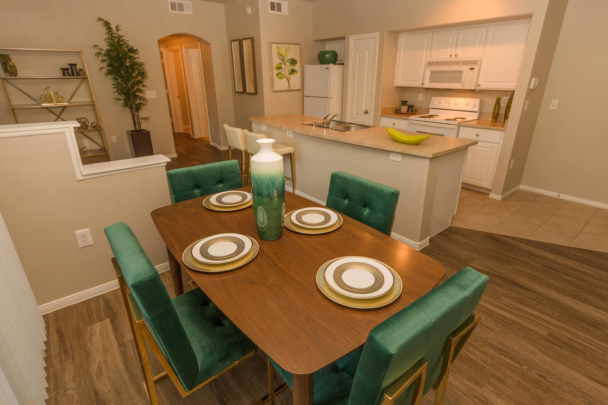 a kitchen with a table and chairs