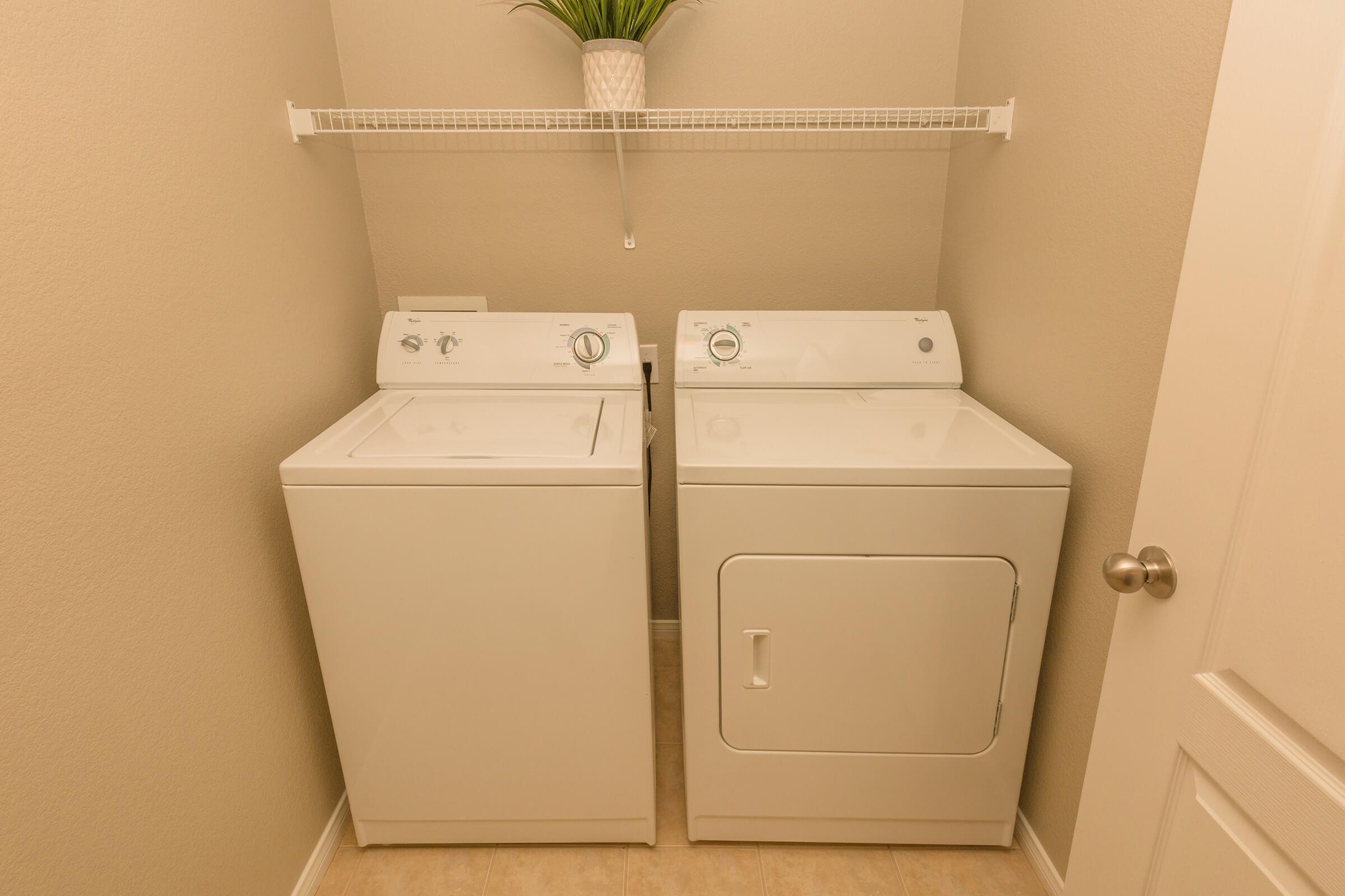 a white sink sitting under a mirror