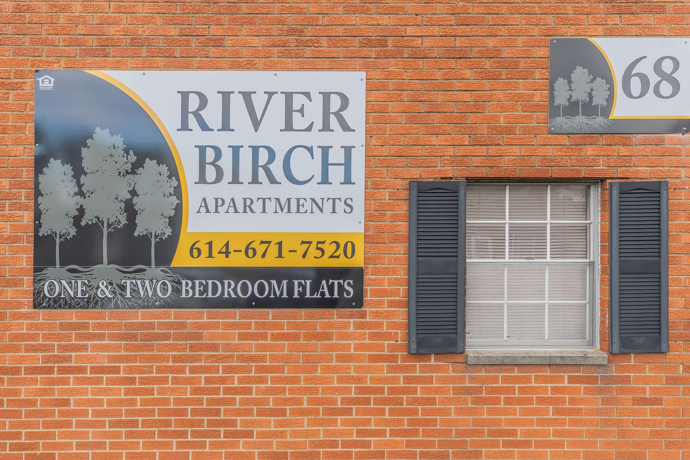 a sign in front of a brick building