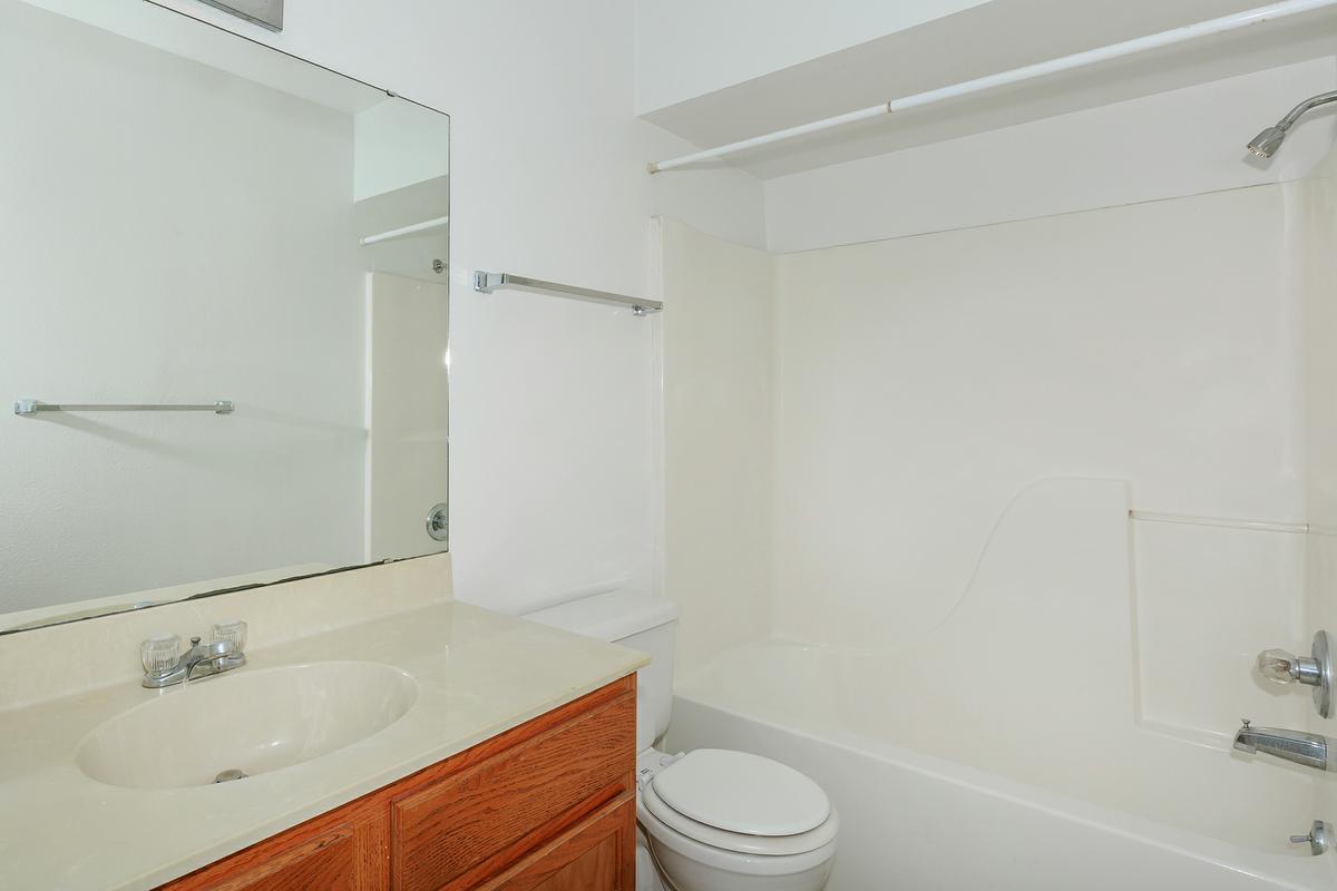 a white tub sitting next to a sink
