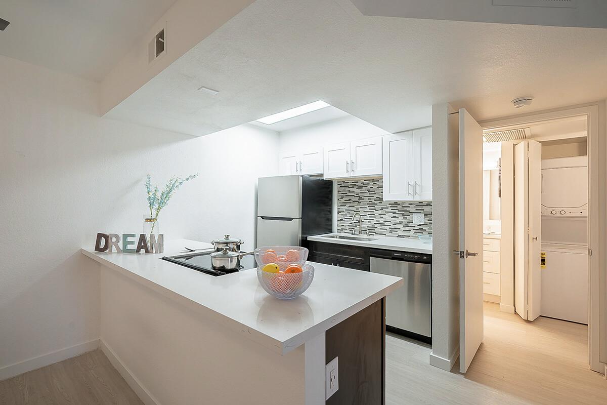 a kitchen with a sink and a mirror