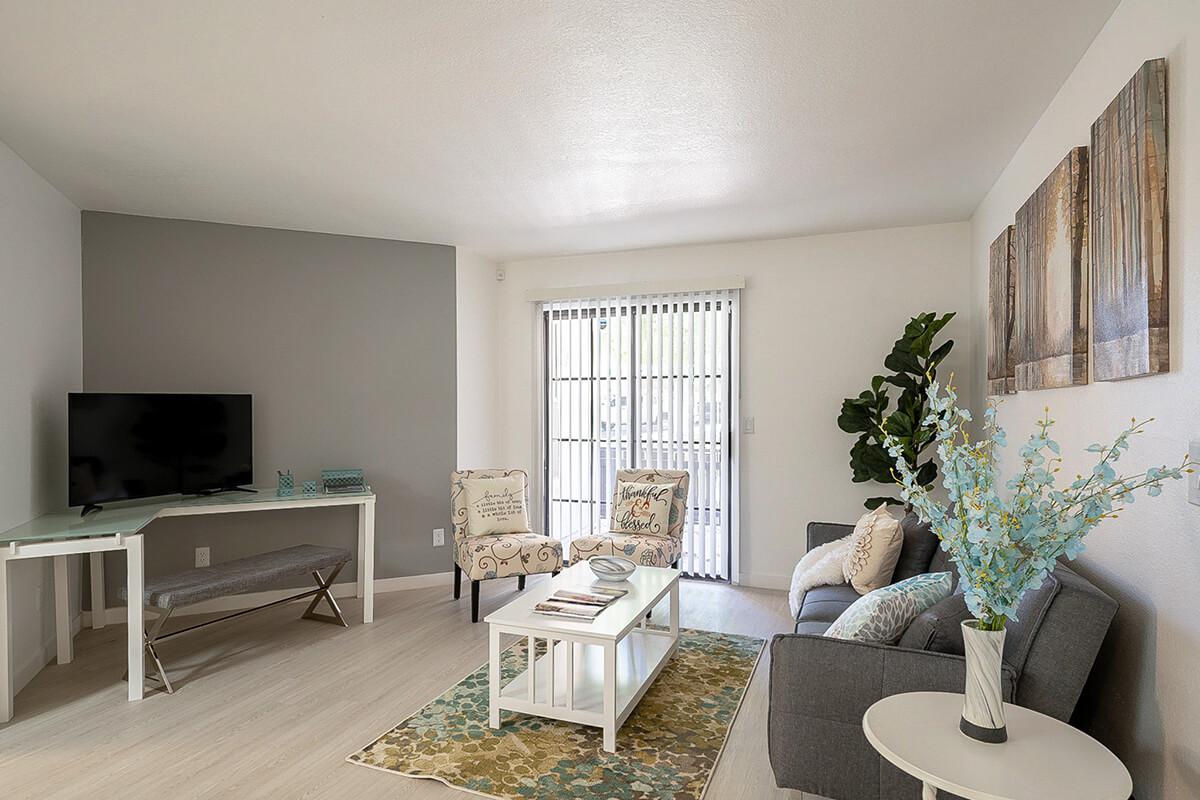 a living room filled with furniture and a large window