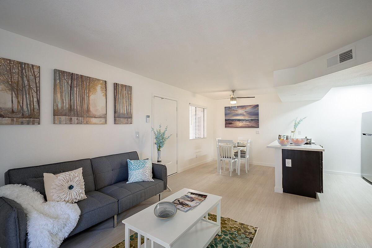 Apartments in Phoenix for Rent - Monaco31 - Open Living Room Next to Kitchen With Modern Furniture and Paintings on the Walls