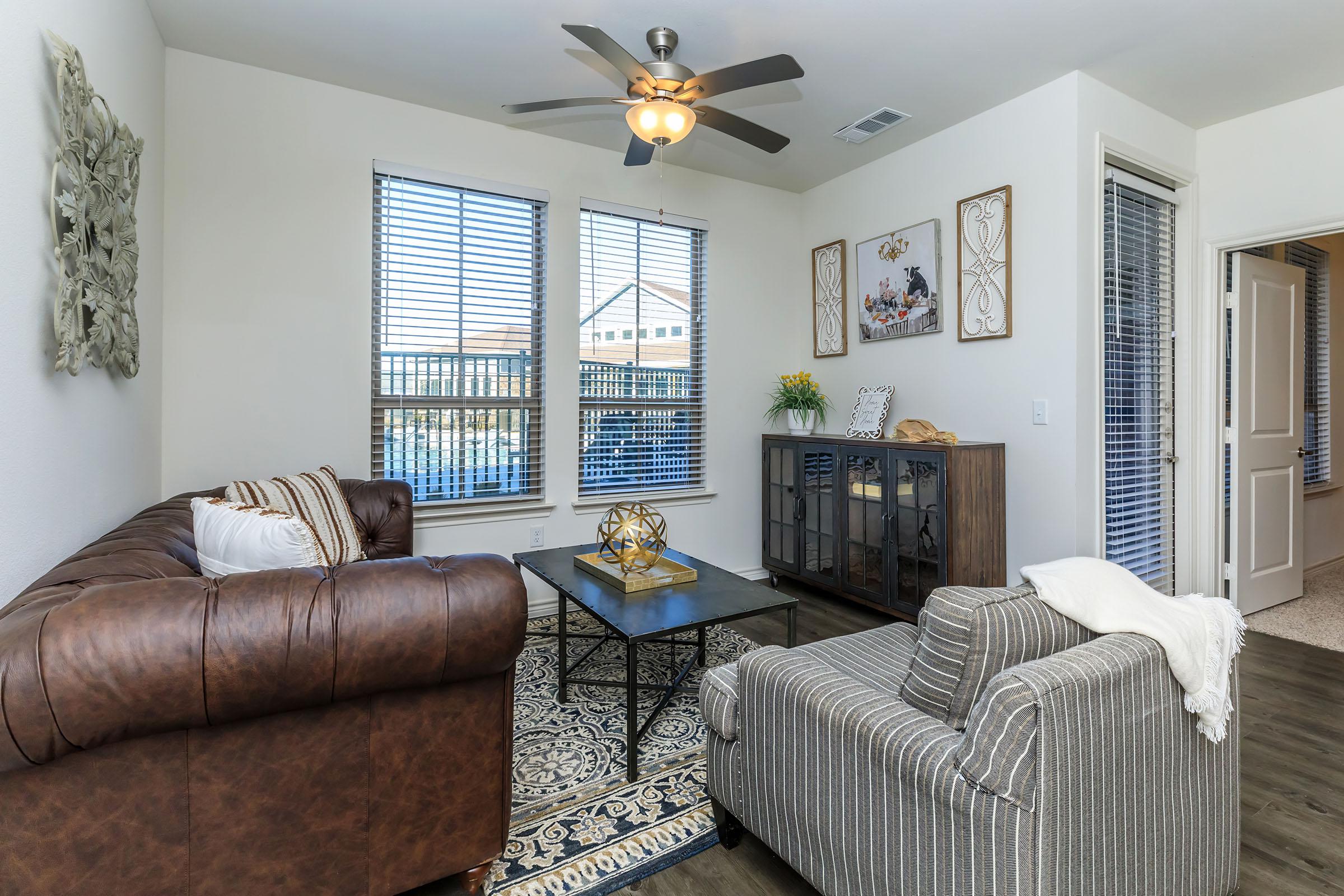 a living room filled with furniture and a large window