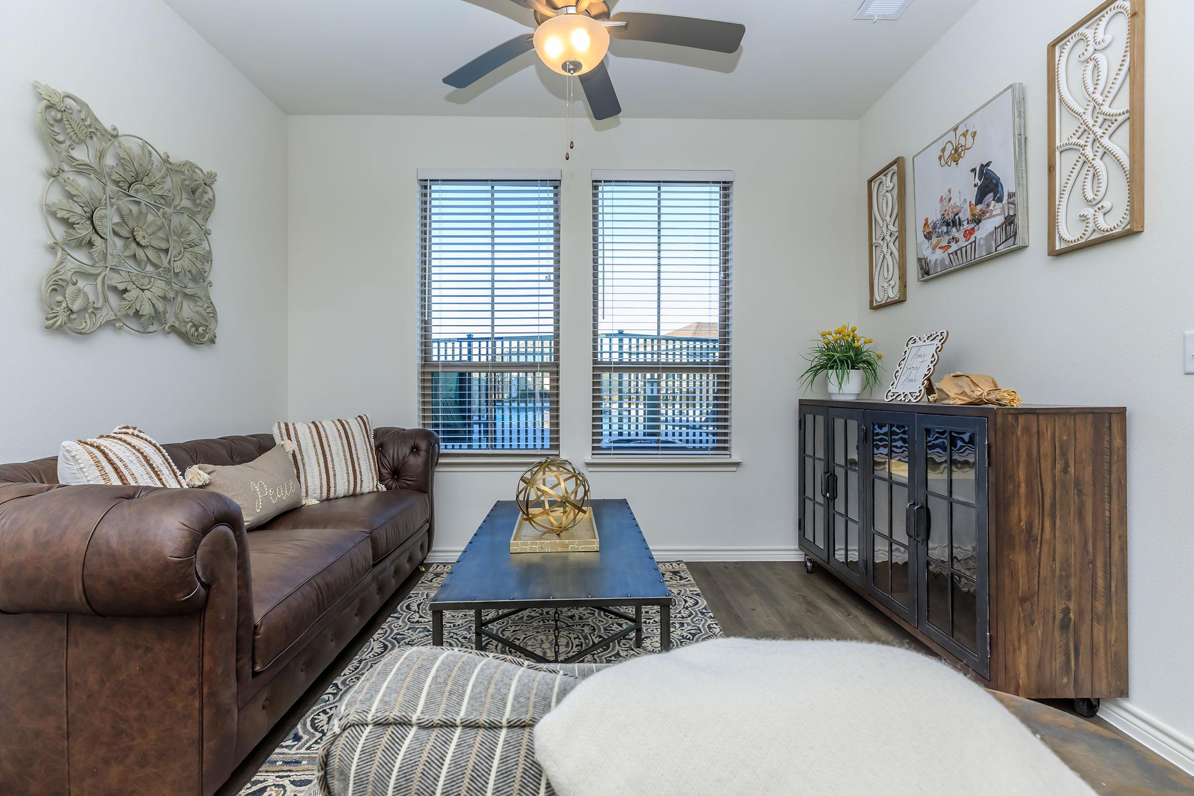 a living room filled with furniture and a large window