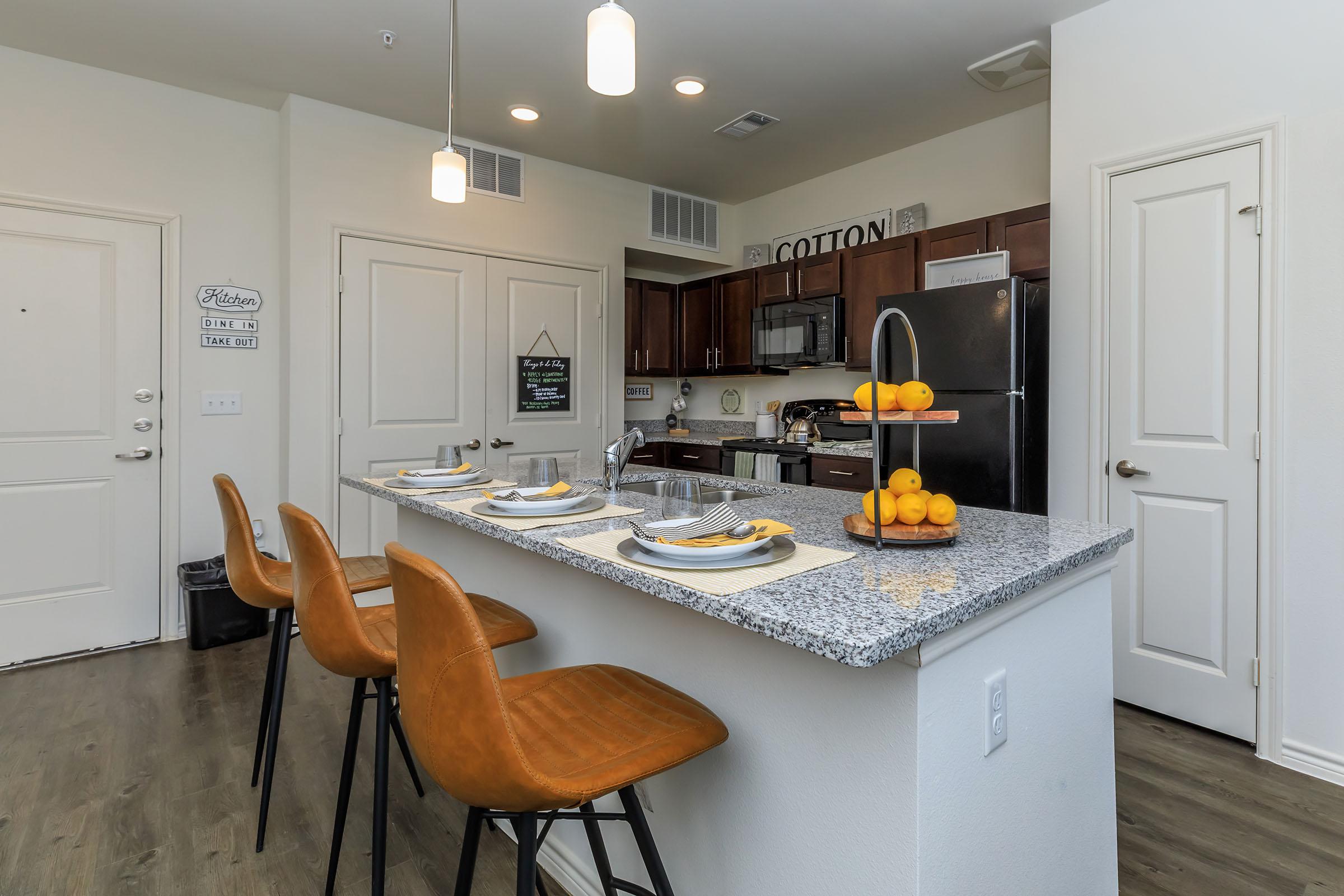 a kitchen with an island in the middle of a table