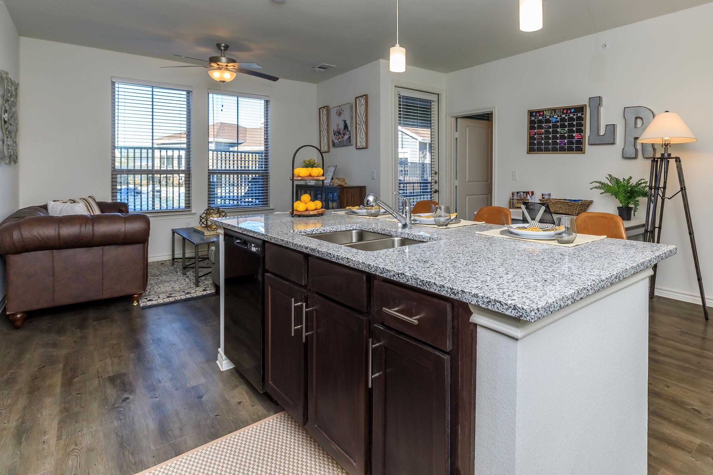 a kitchen with a sink and a mirror in a room