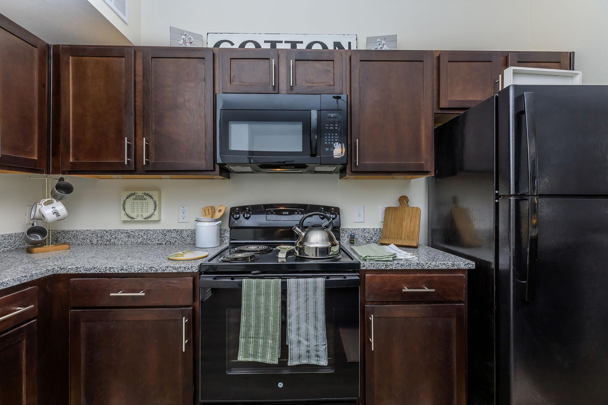 a kitchen with stainless steel appliances and wooden cabinets