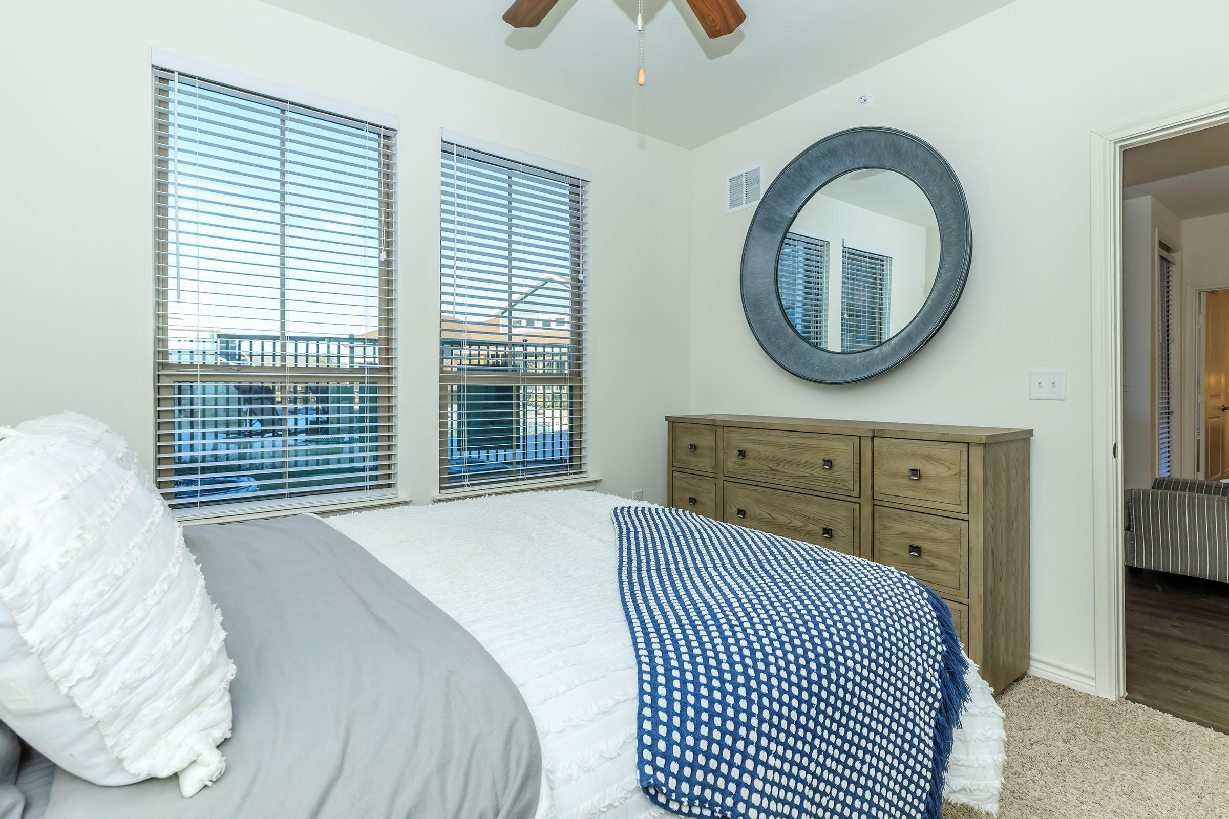 a living room with a bed and a window