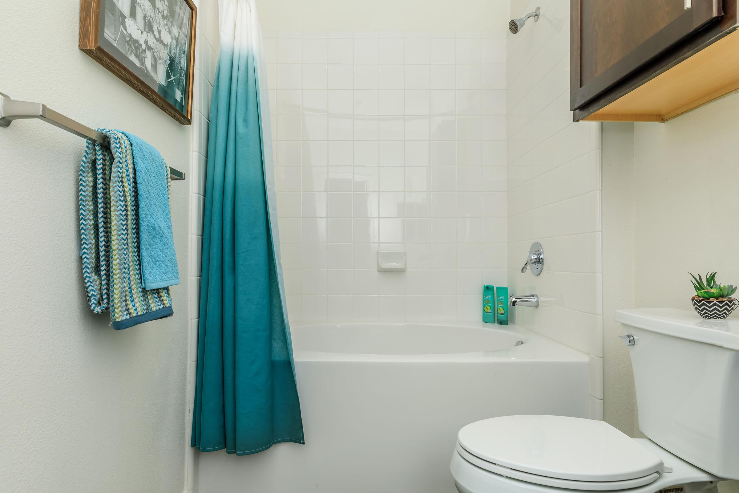 a shower with a towel hanging on the wall