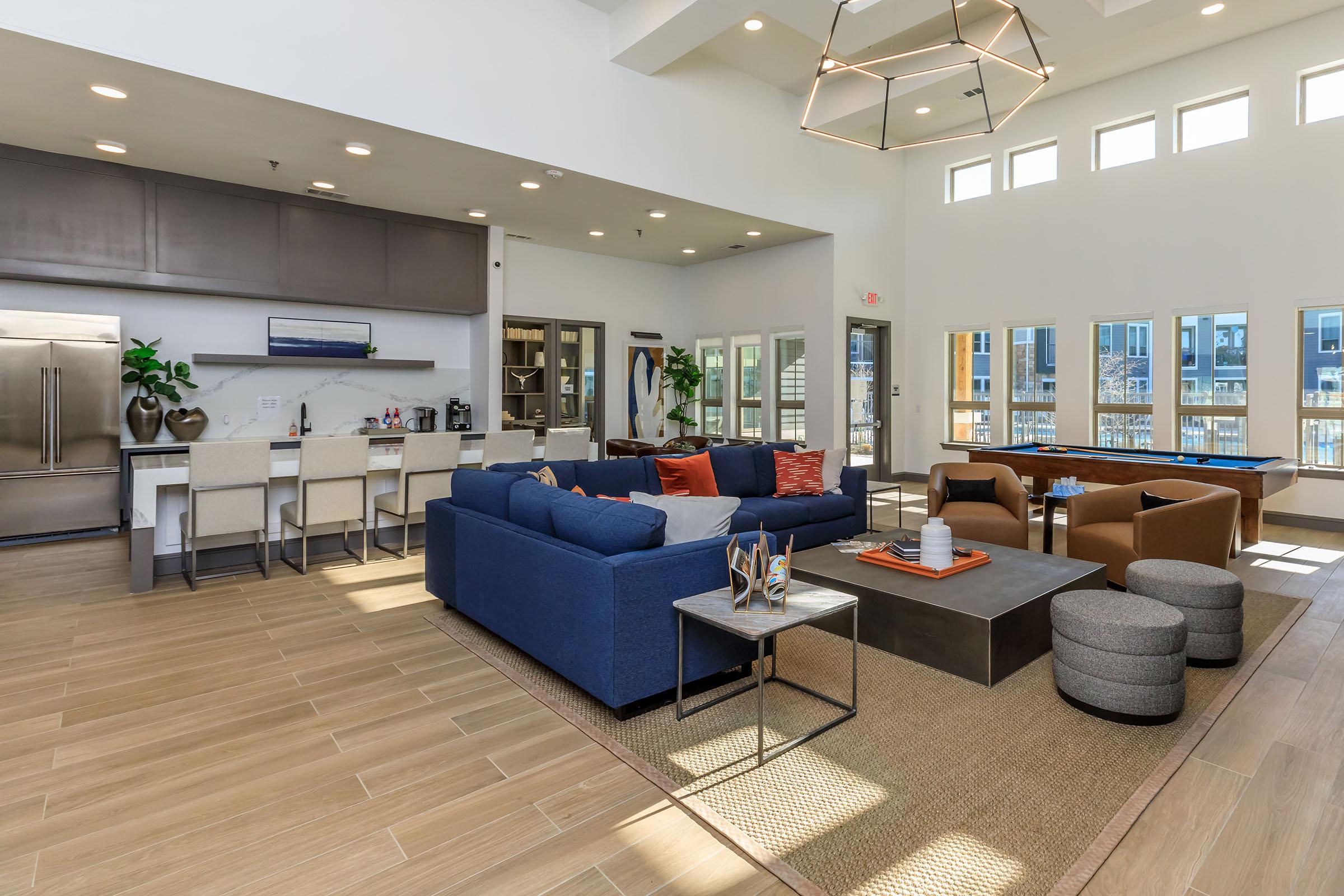 a living room filled with furniture and a large window