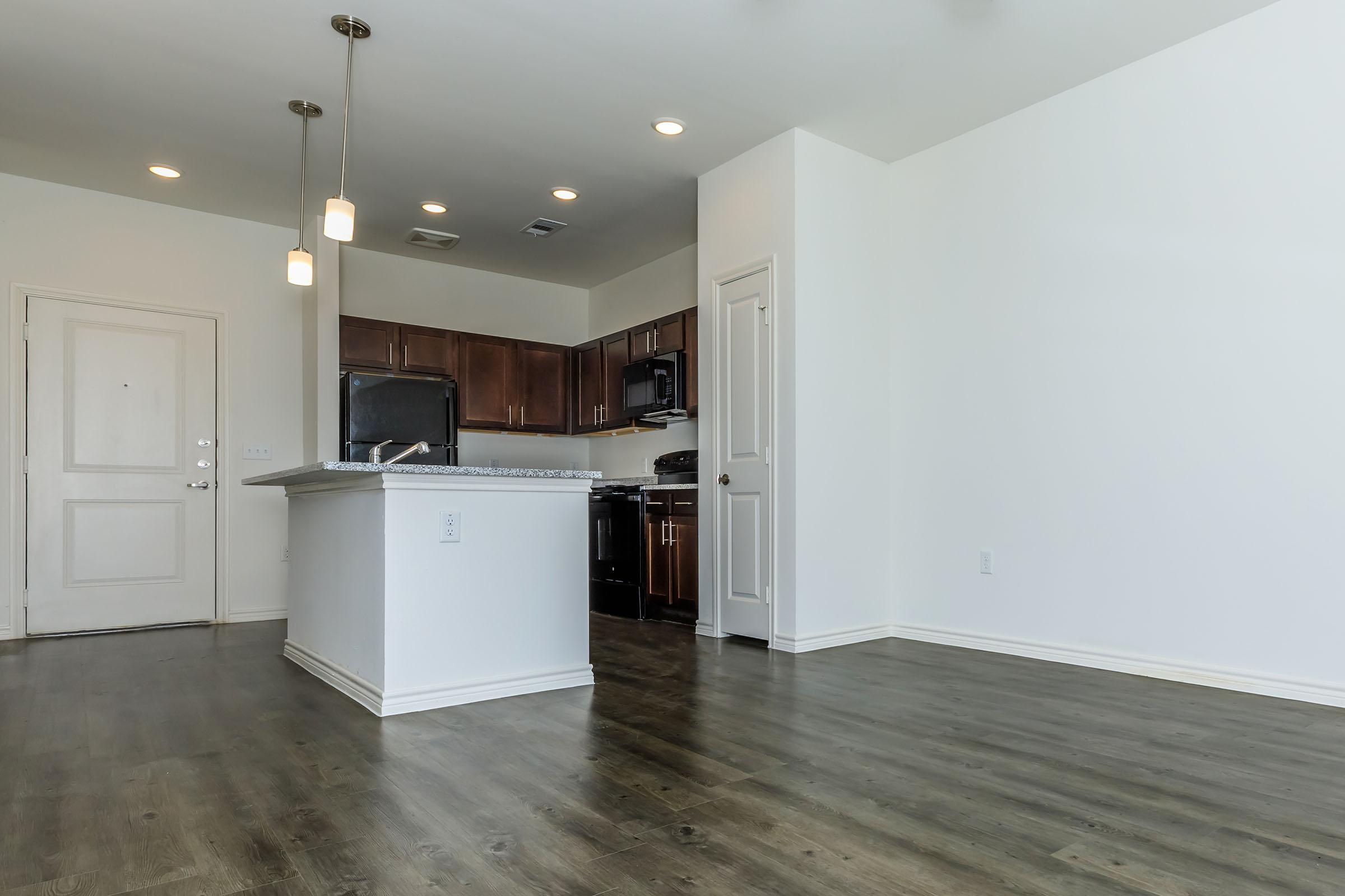 a kitchen area with a building in the background