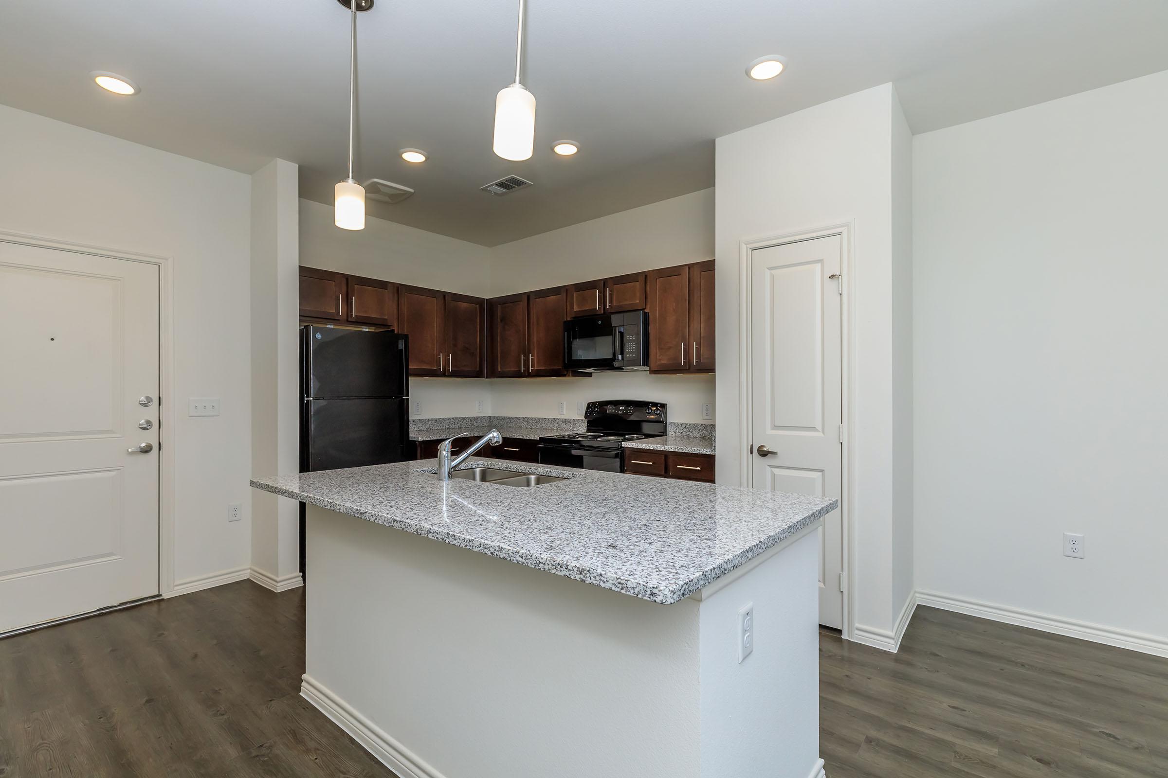 a kitchen with a sink and a refrigerator