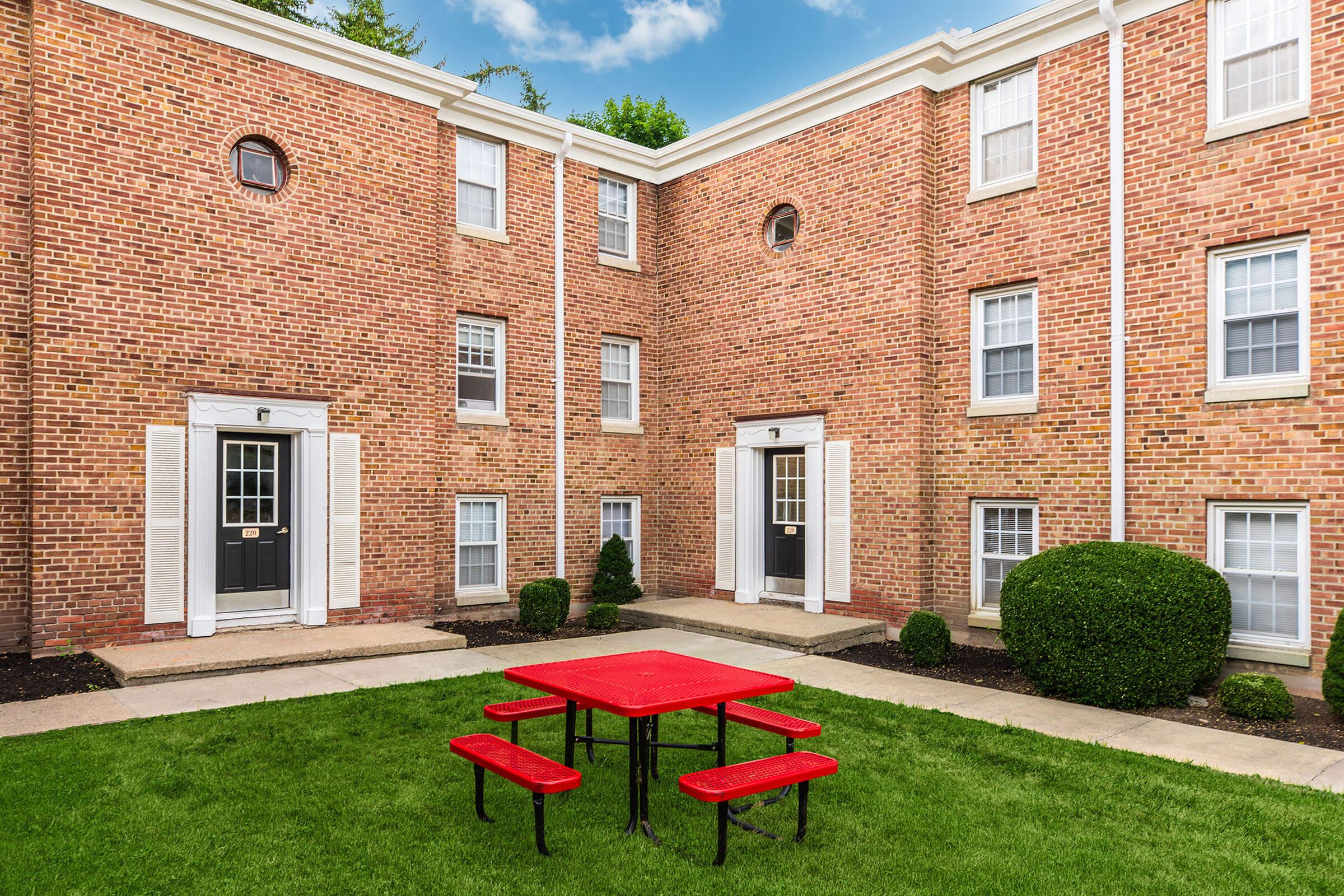 a large lawn in front of a brick building