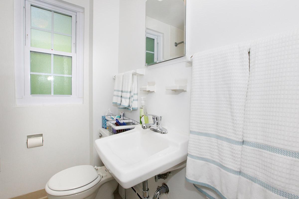 a white sink sitting under a window