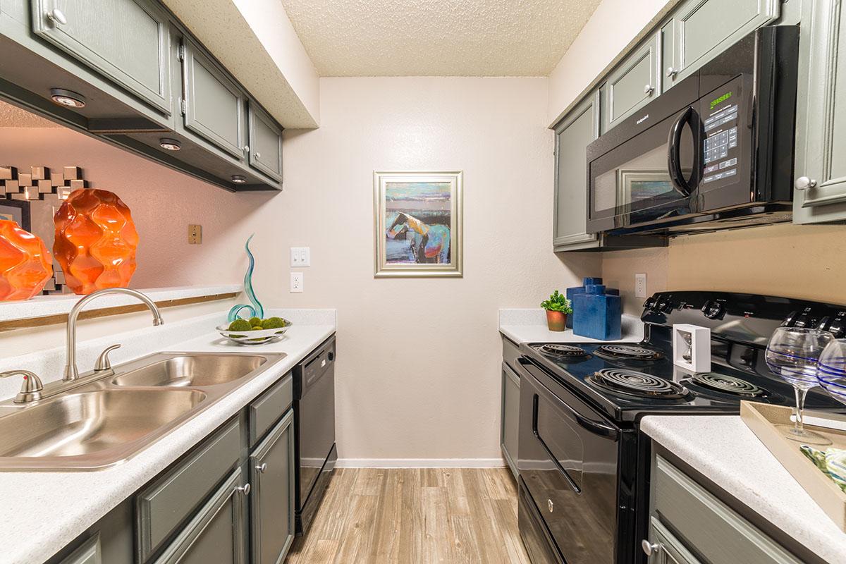a kitchen with a stove and a sink