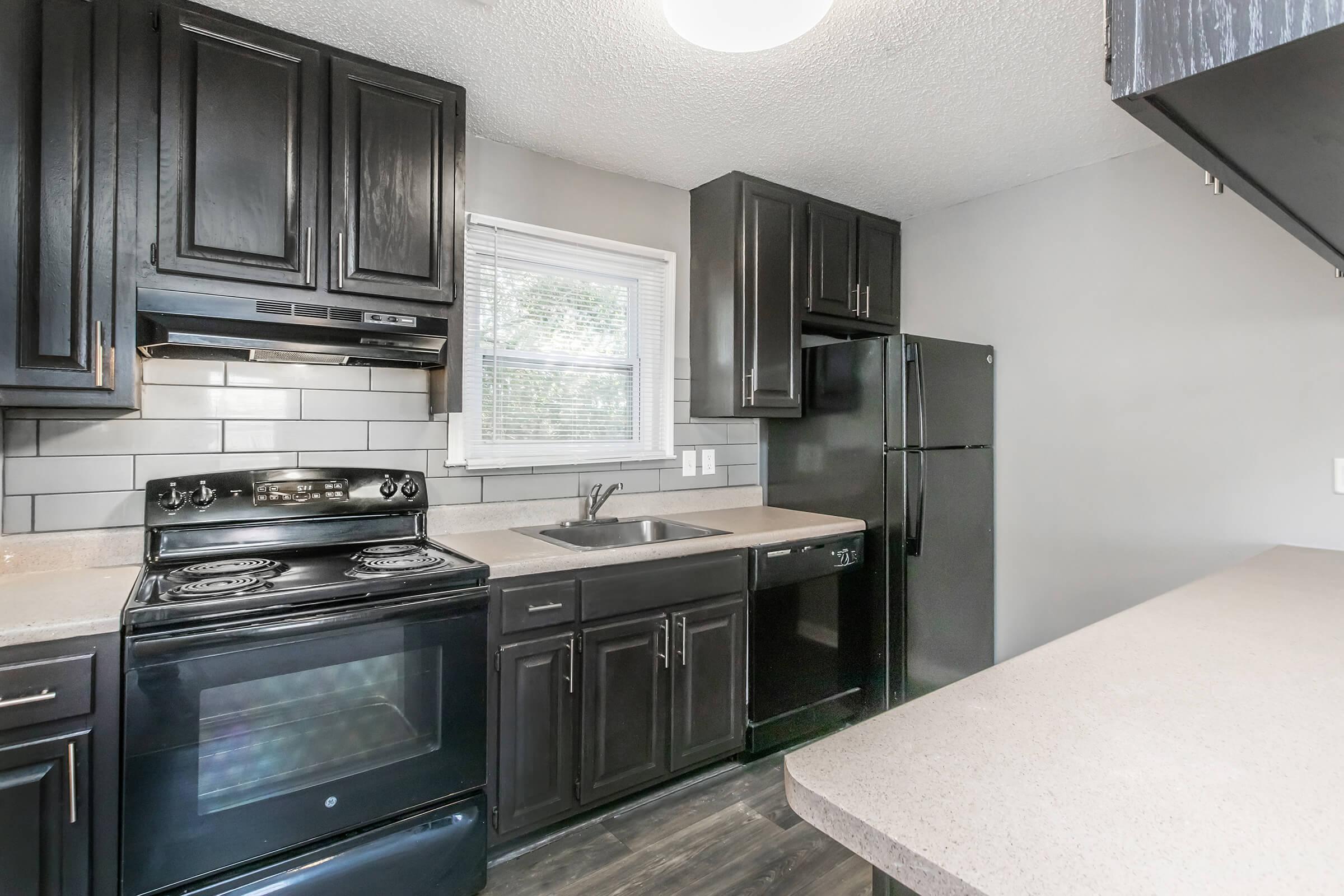 a modern kitchen with stainless steel appliances and wooden cabinets