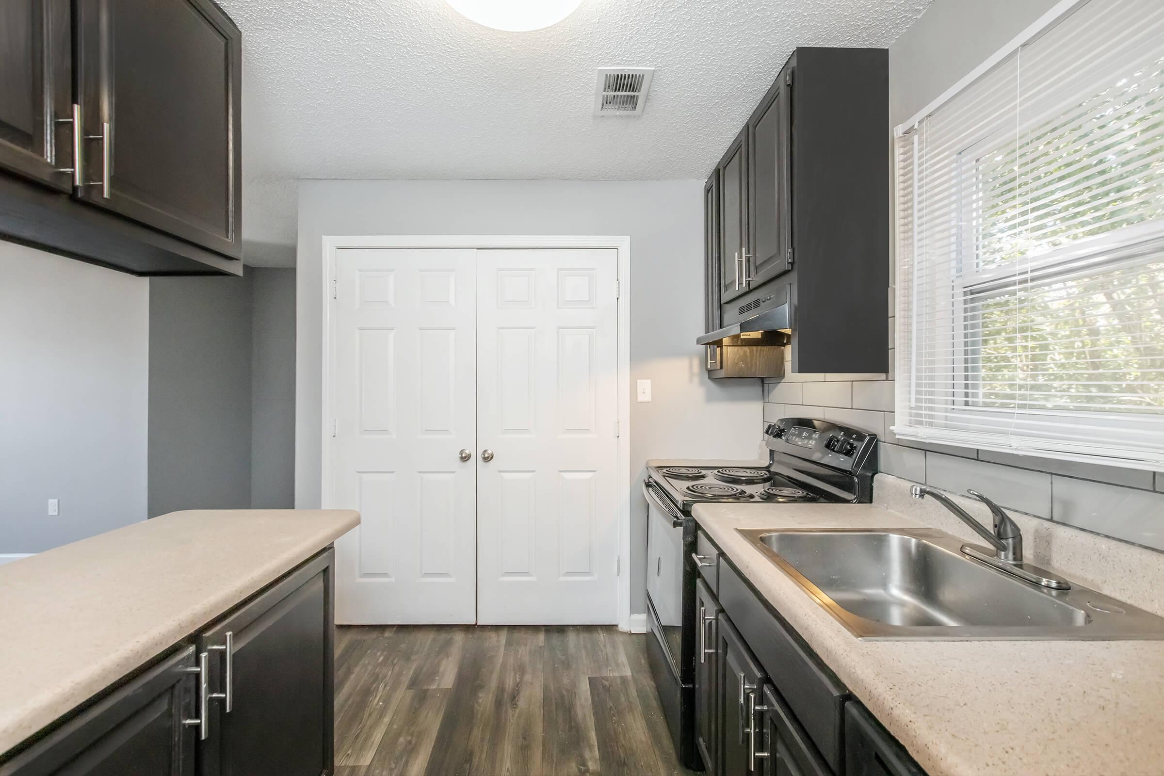 a kitchen with a stove and a sink