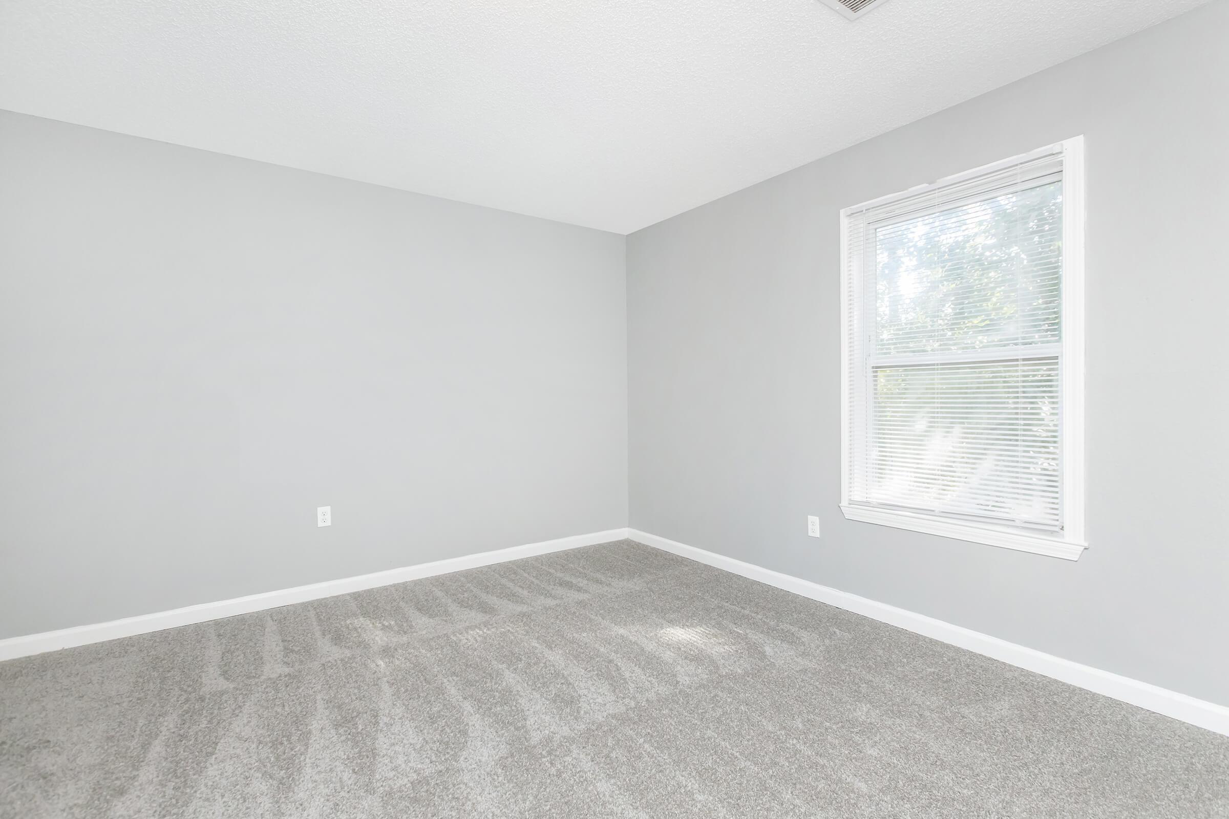 a bedroom with a large window